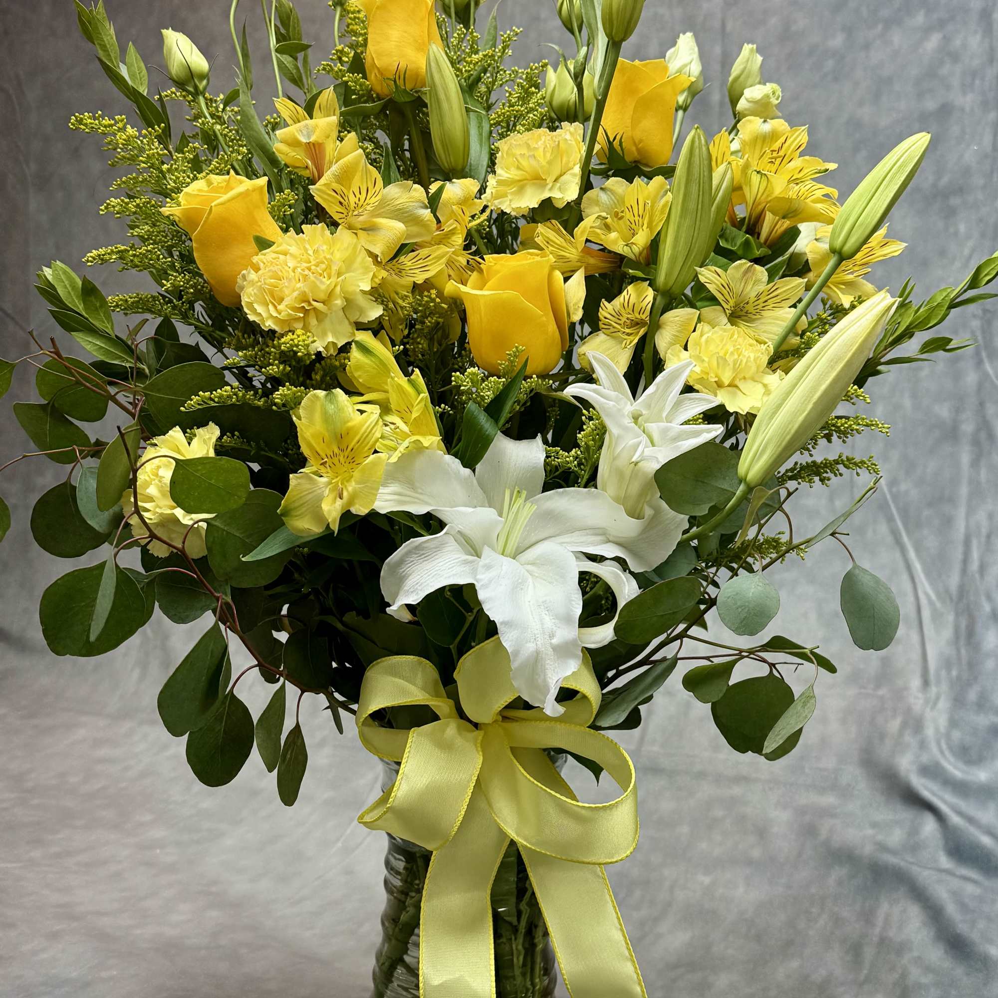 A refreshing blend of vibrant yellow roses and spray roses , yellow A refreshing blend of vibrant yellow roses and spray roses , yellow