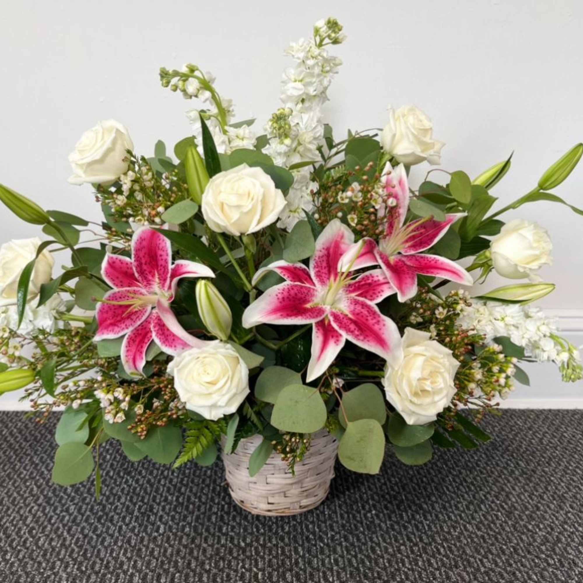 A beautiful basket of blooms of pinks and whites including lilies, rose A beautiful basket of blooms of pinks and whites including lilies, rose