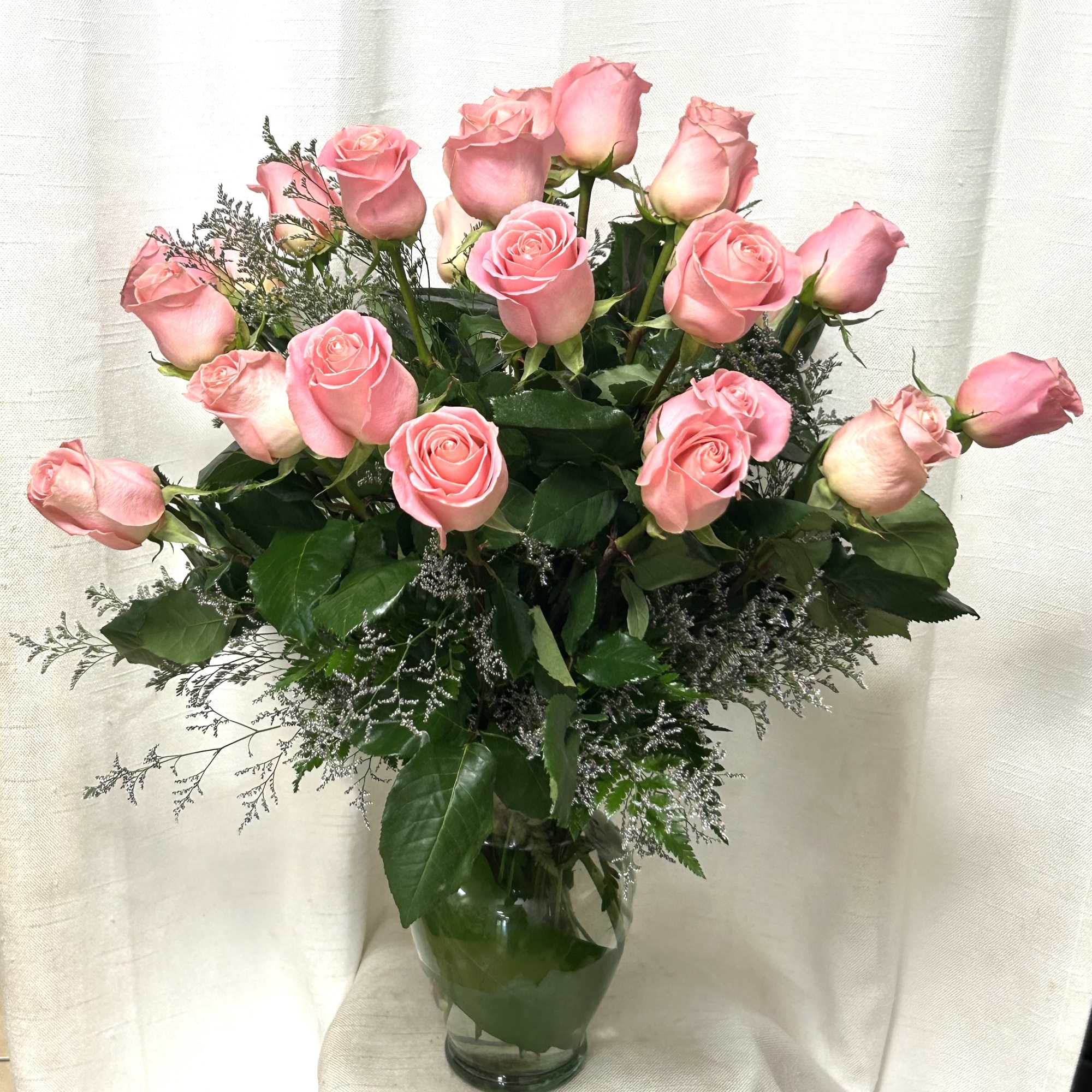 This exquisite flower arrangement showcases the timeless beauty of 12 long stem