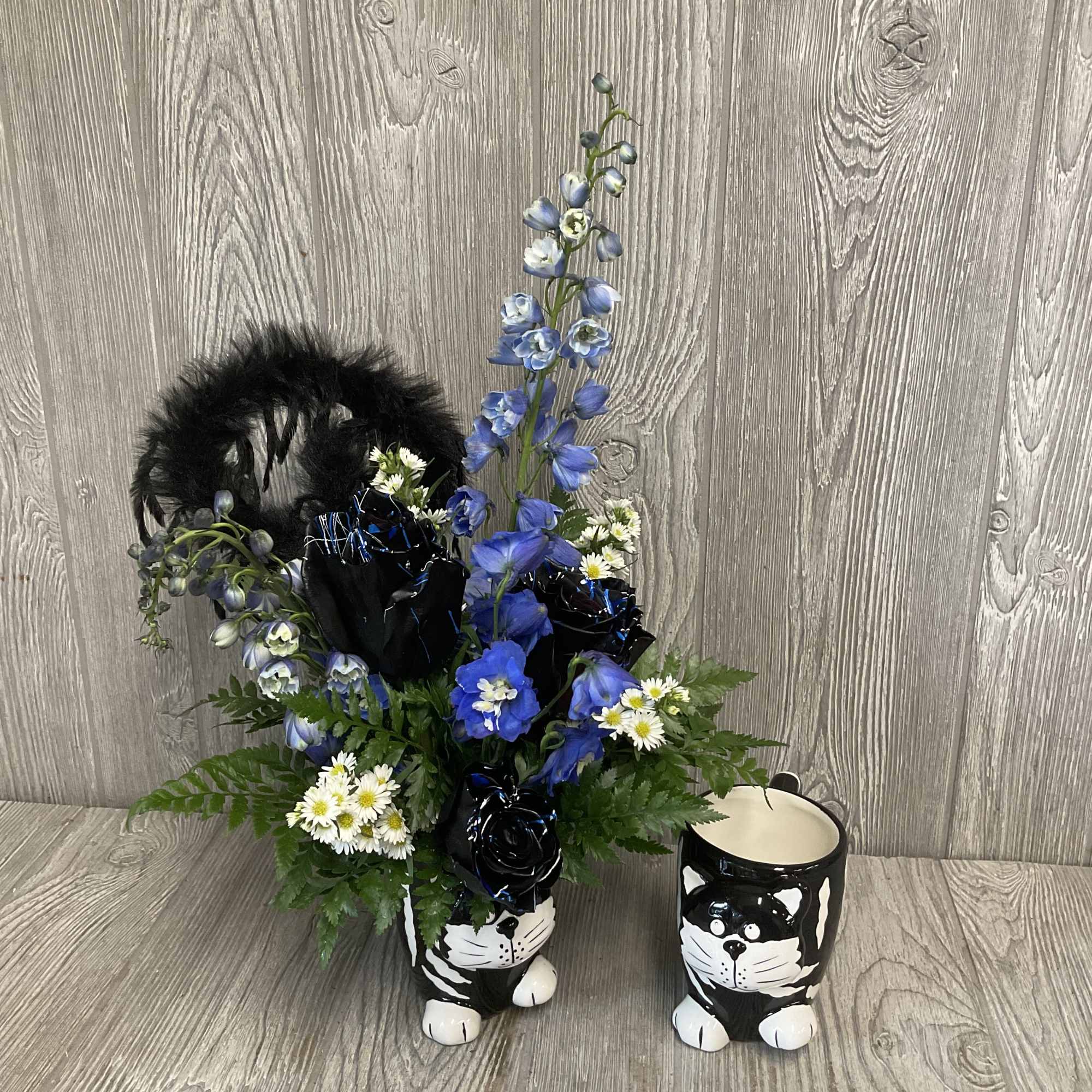 Fresh cut flowers in a keepsake ceramic cat mug. Flowers and colors