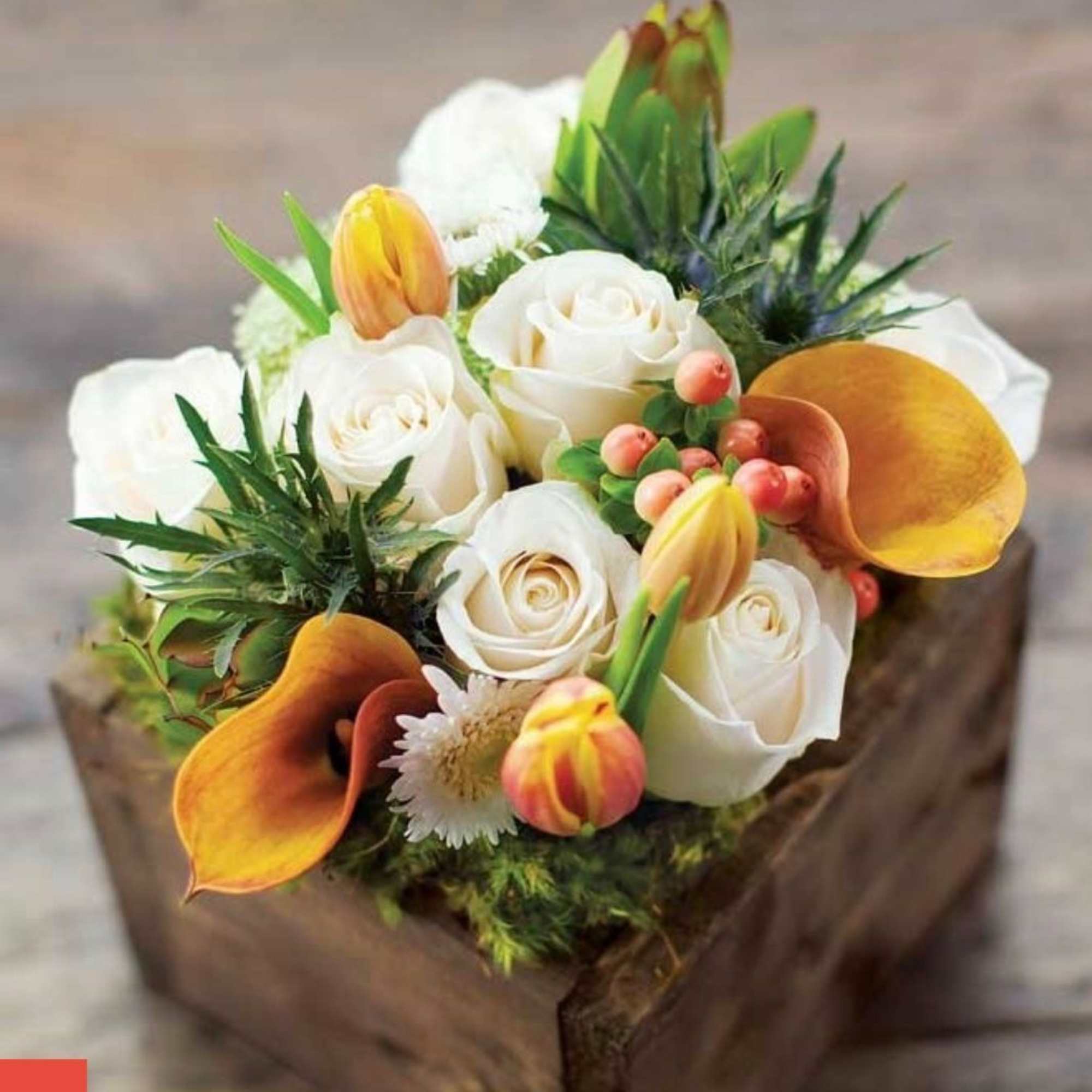 Wooden box fill with seasonal flowers combination .
Very popular floral arrangement with