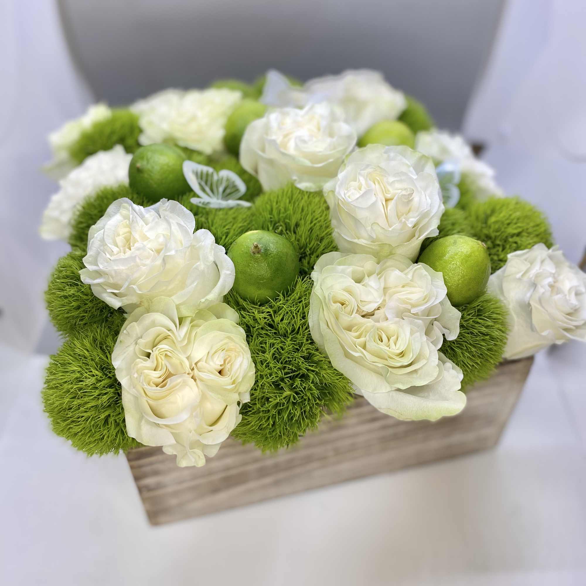 Wooden box fill with seasonal flowers combination .
Very popular floral arrangement with