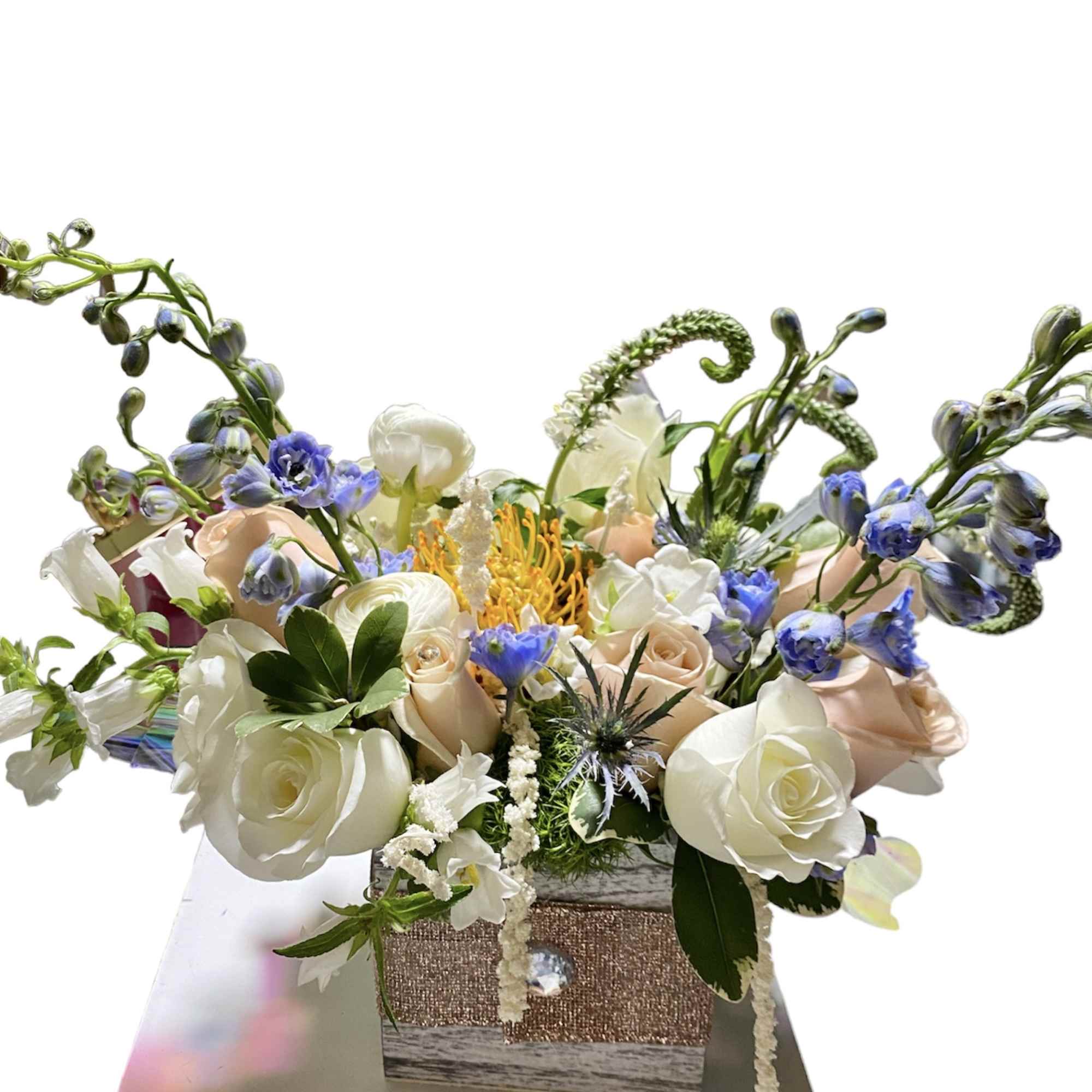 wood box with accent of sparks fill with premium seasonal flowers 