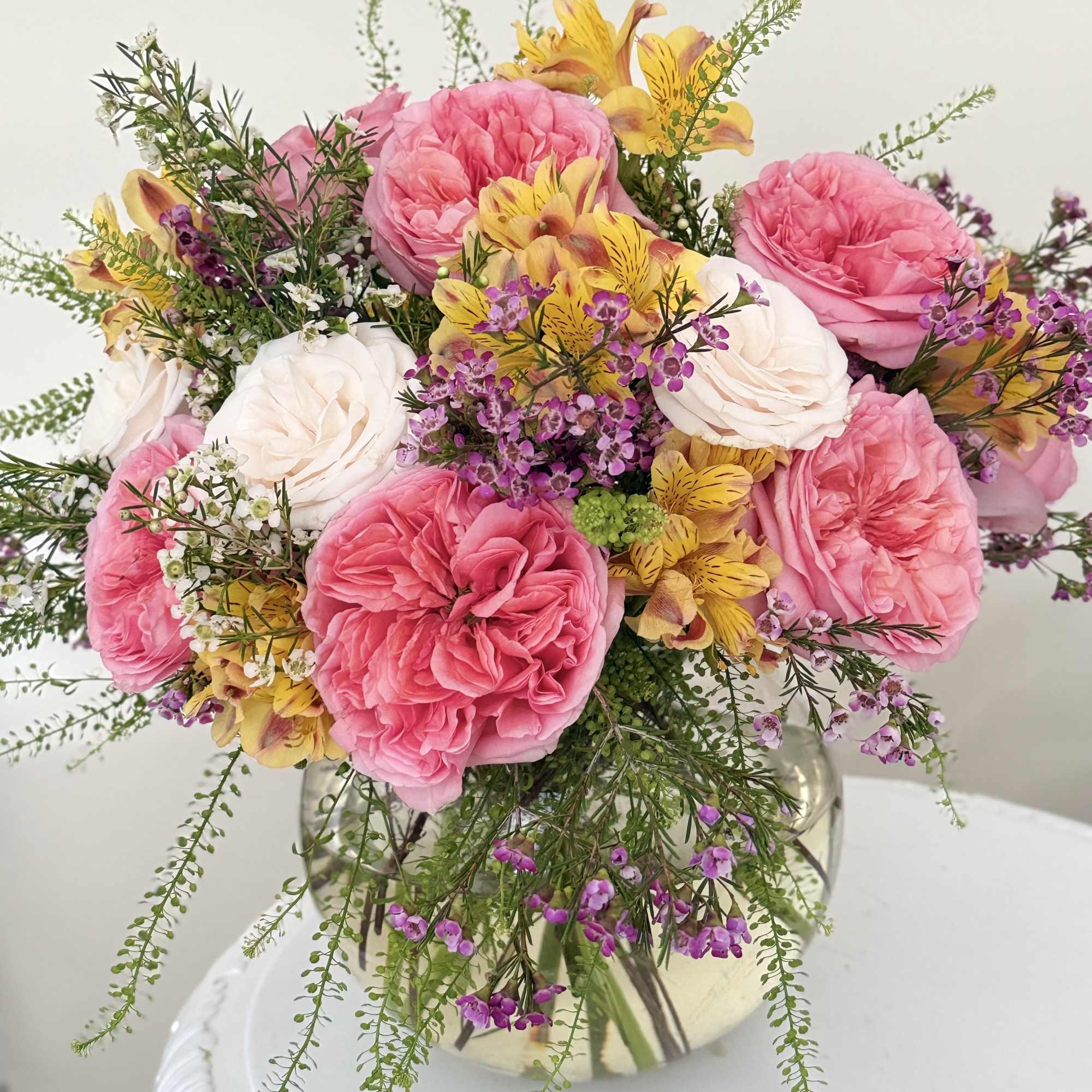 Soft garden roses in warm shades, calm as the valley they bloom