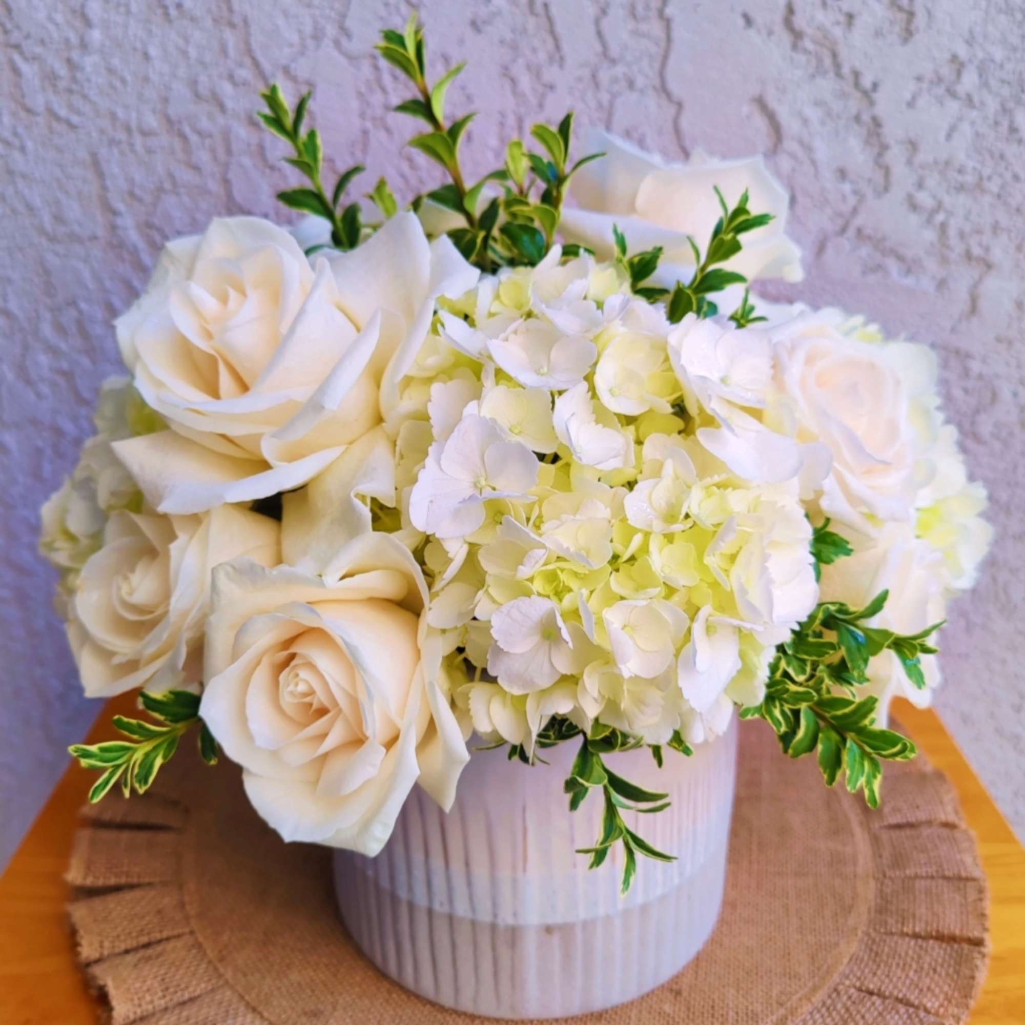 Beautiful white hydrangea arrangement. It&#039;s created with premium white roses, seasonal foliage