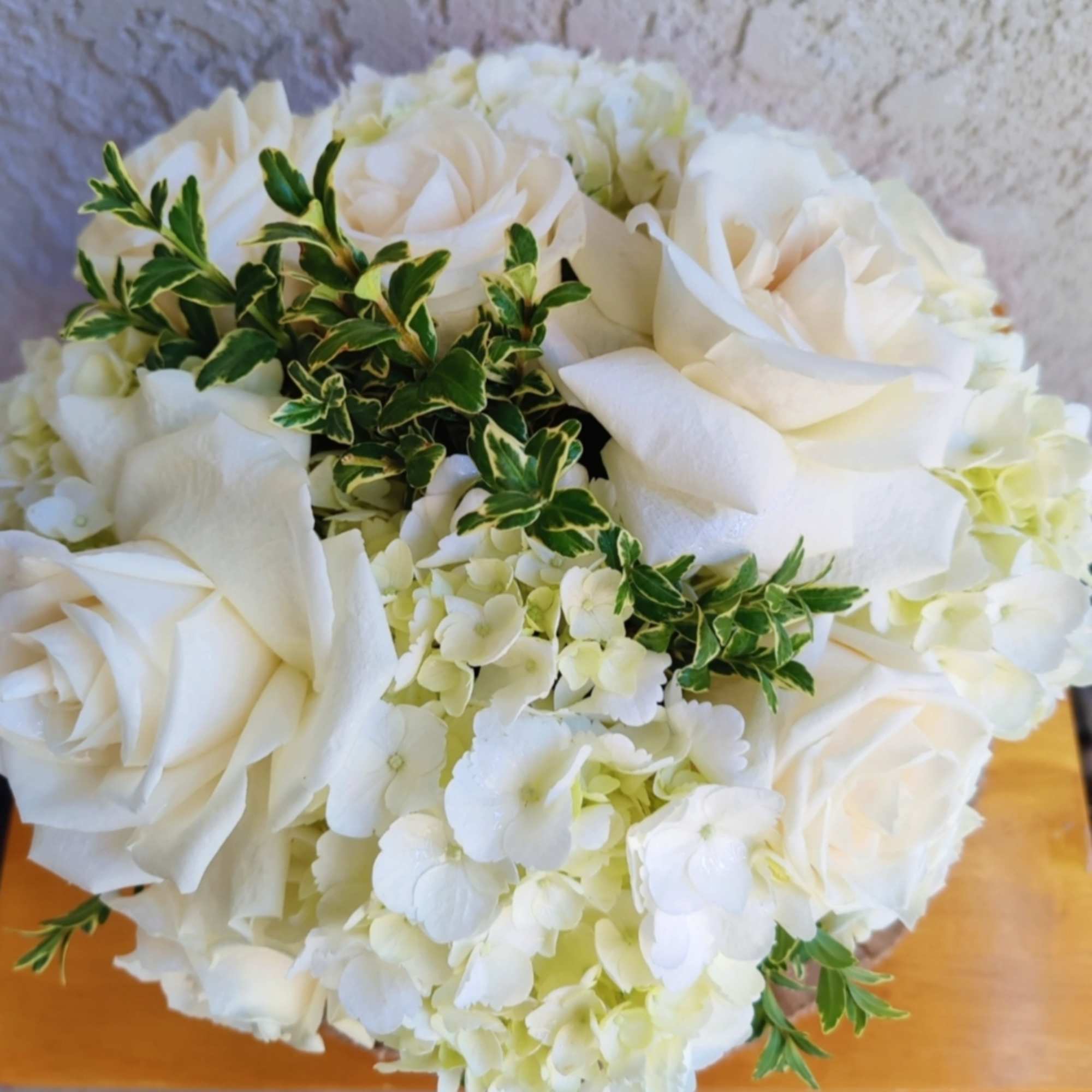 Beautiful white hydrangea arrangement. It&#039;s created with premium white roses, seasonal foliage