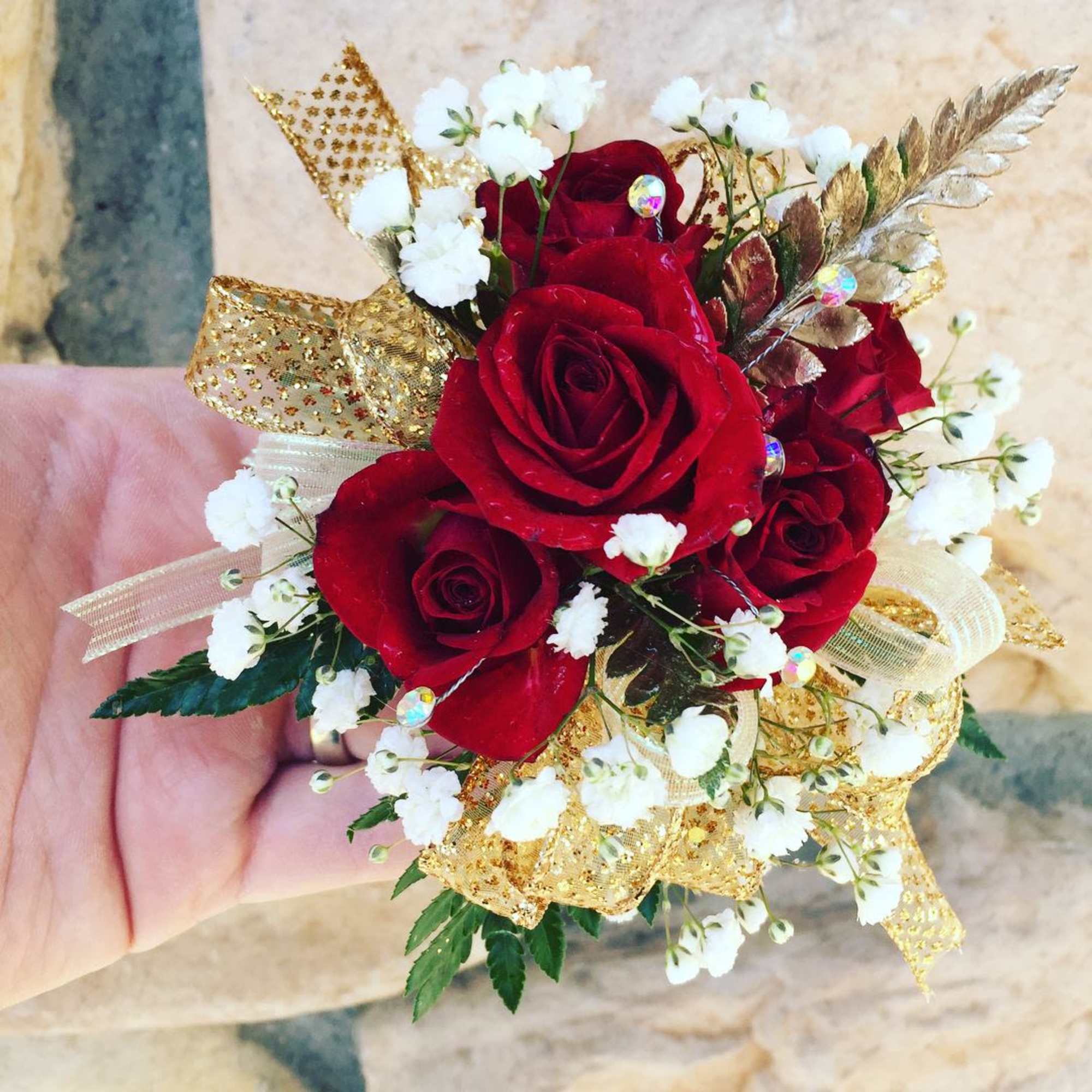 This is made with spray roses, filler flowers, and greenery. We ribbon