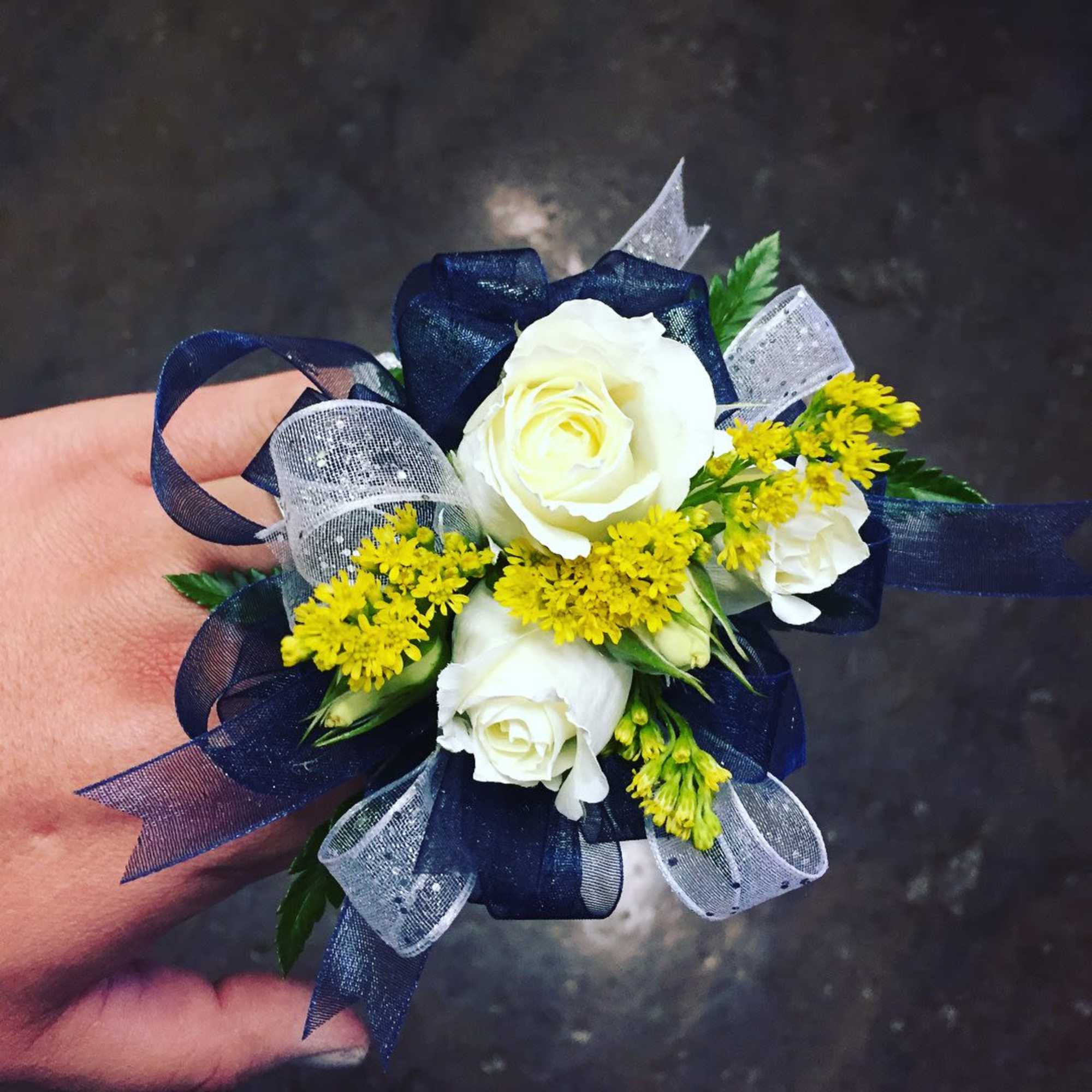 This is made with spray roses, filler flowers, and greenery. We ribbon