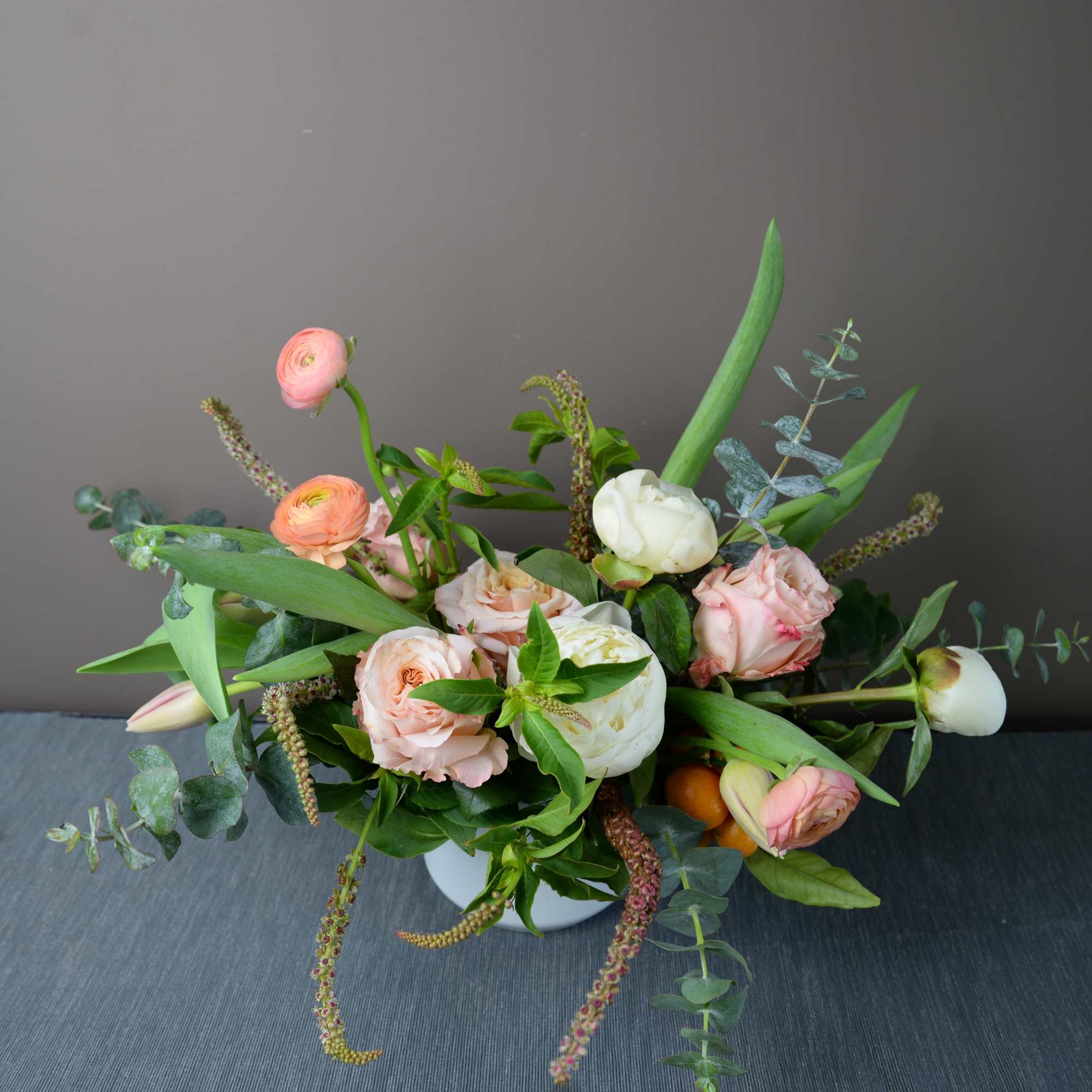 A designer's choice arrangement of seasonal blooms arranged more loose and airy A designer's choice arrangement of seasonal blooms arranged more loose and airy