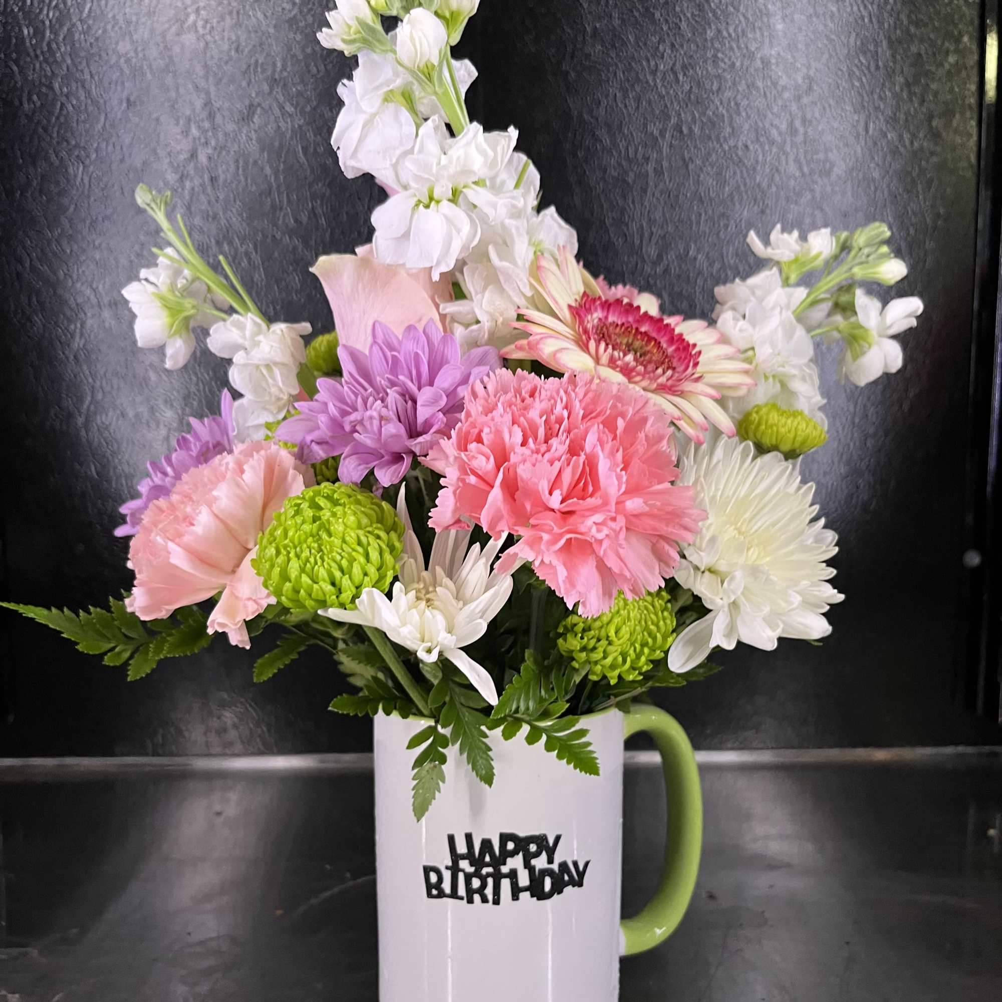 Fresh flowers in coffee mug 