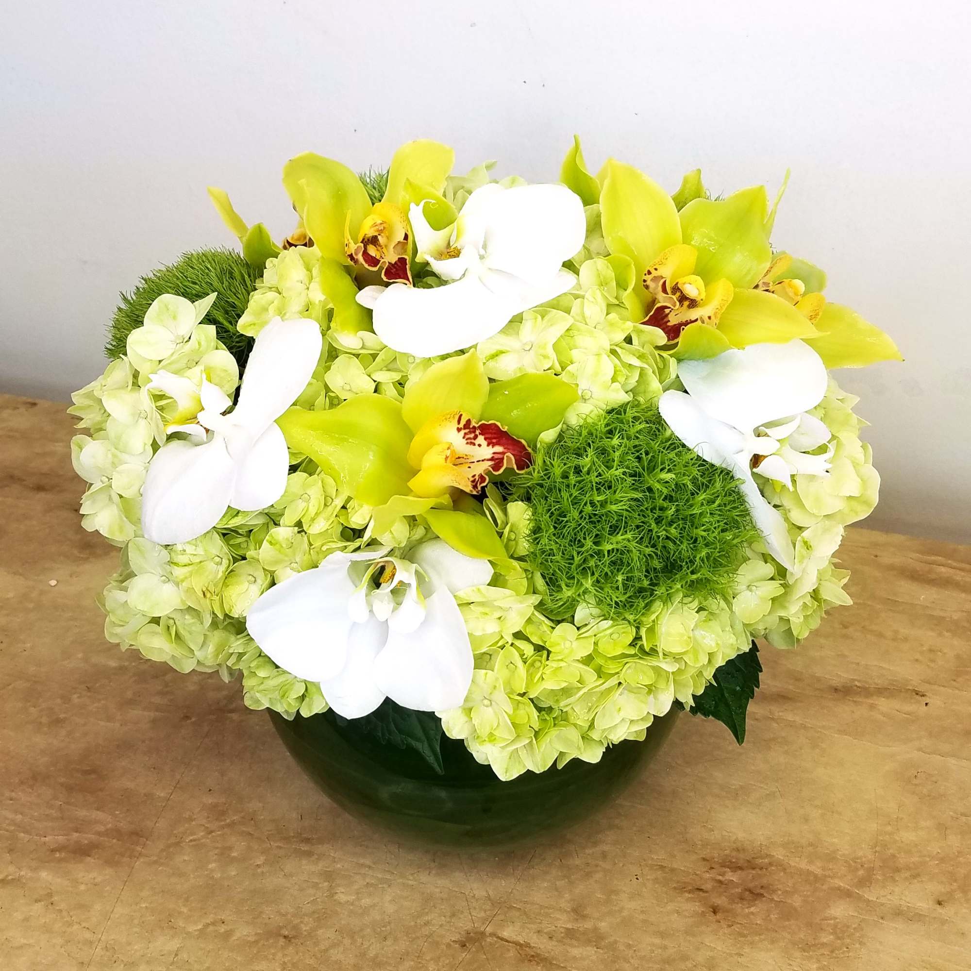 Two different types of orchids and hydrangea come together for this bubble