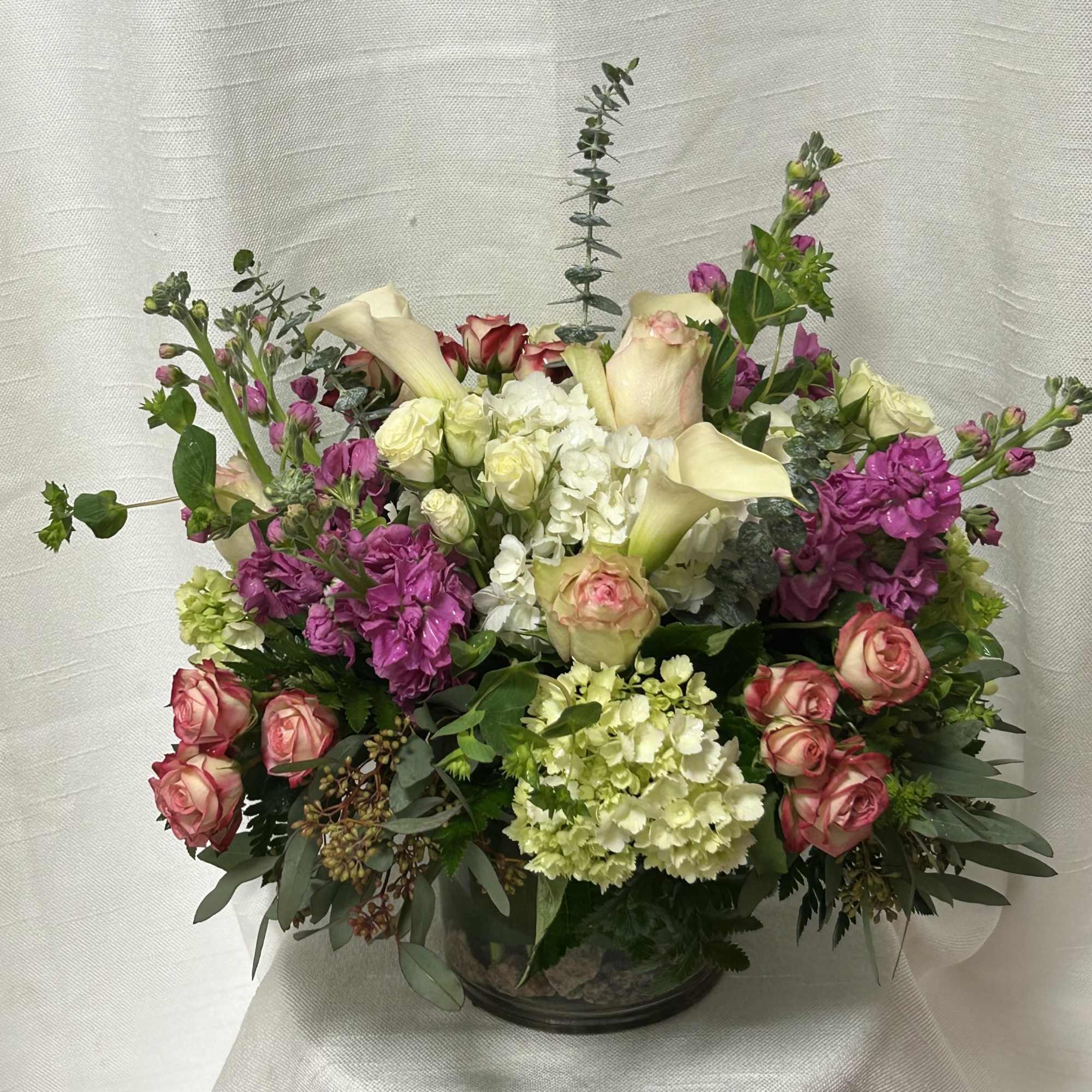 Introducing our premium floral arrangement, dazzling with shades of green, white, pink