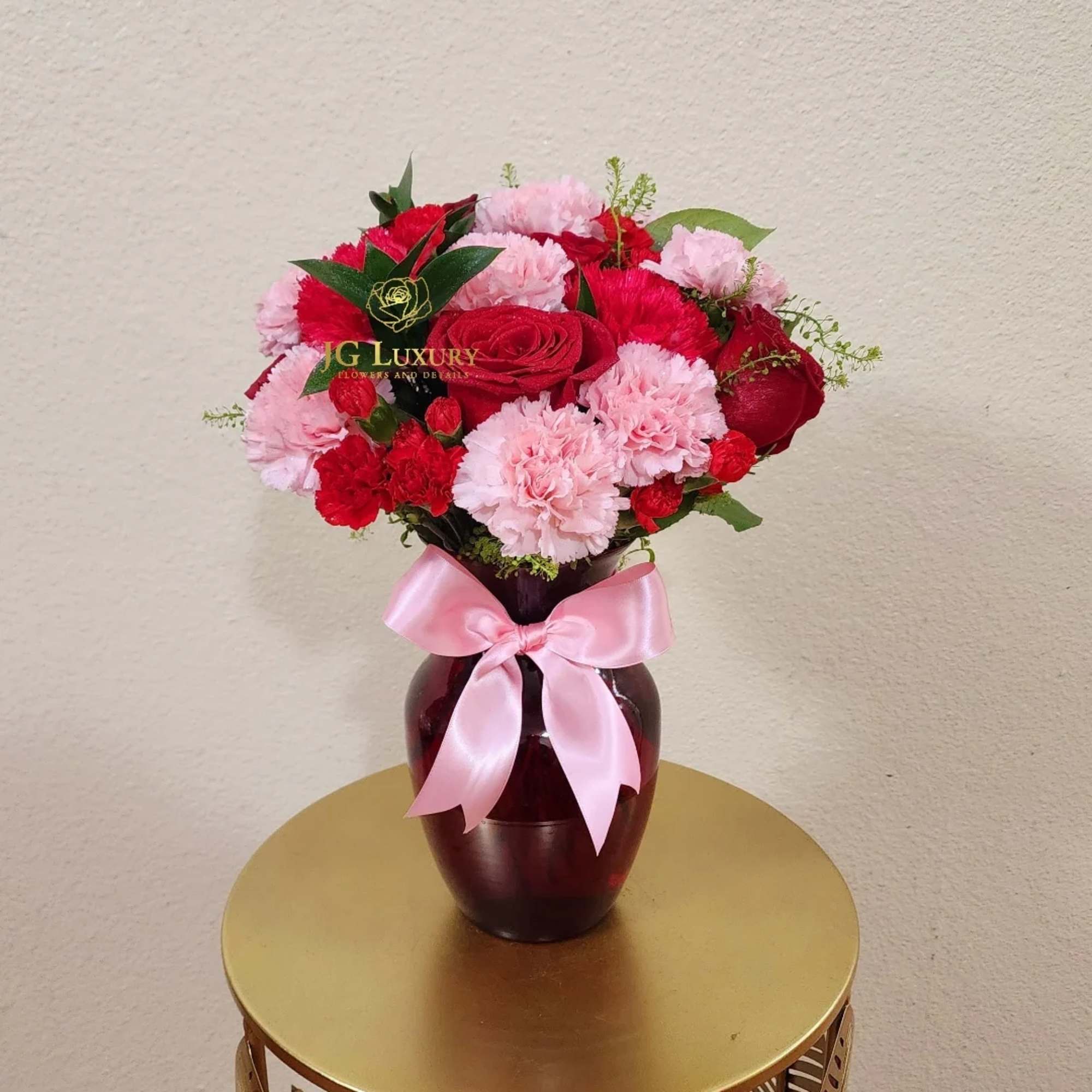 Carnations, roses, greens, rucus and mini carnations means a mix of blooms