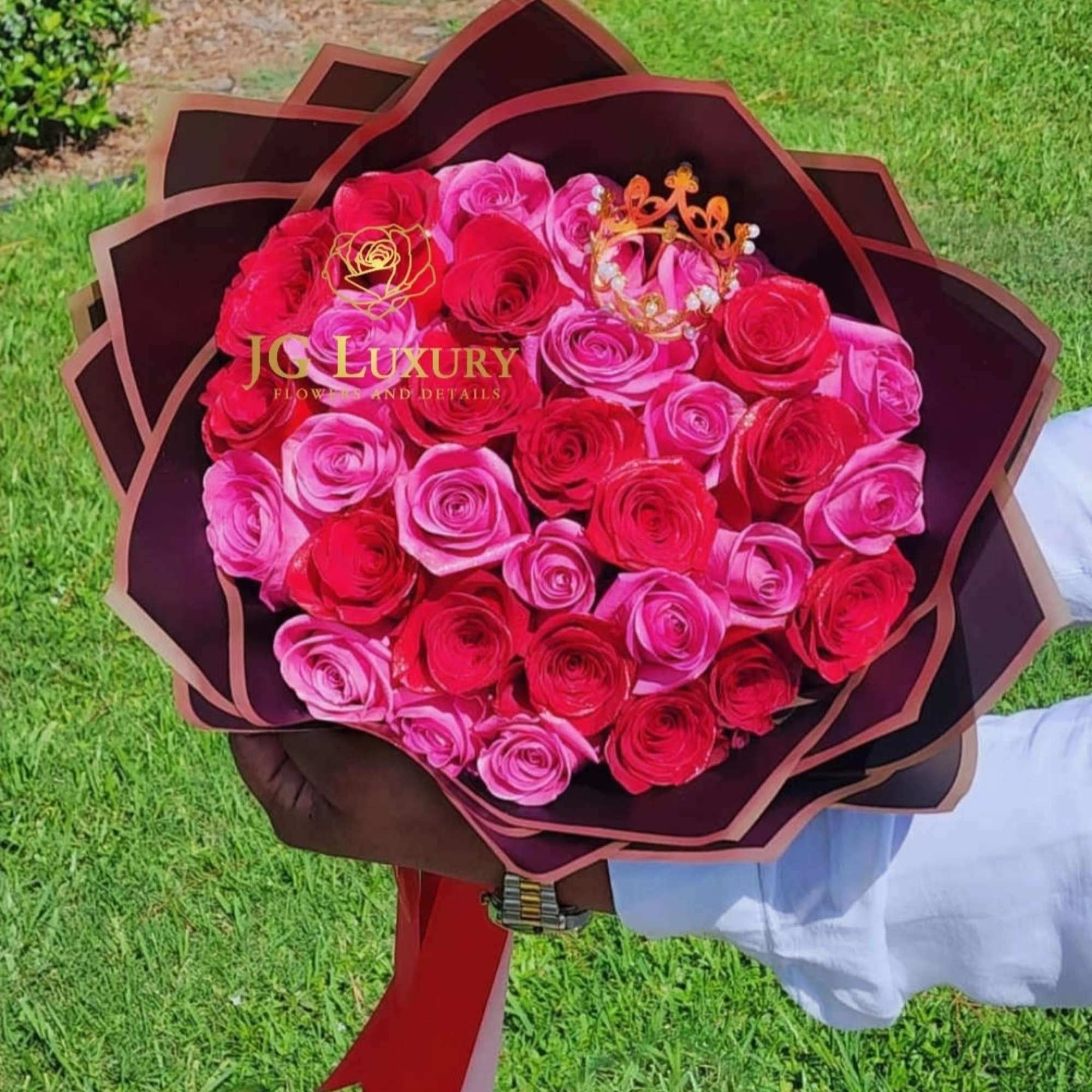 Two dozen of red and pink roses with a touch of royalty
