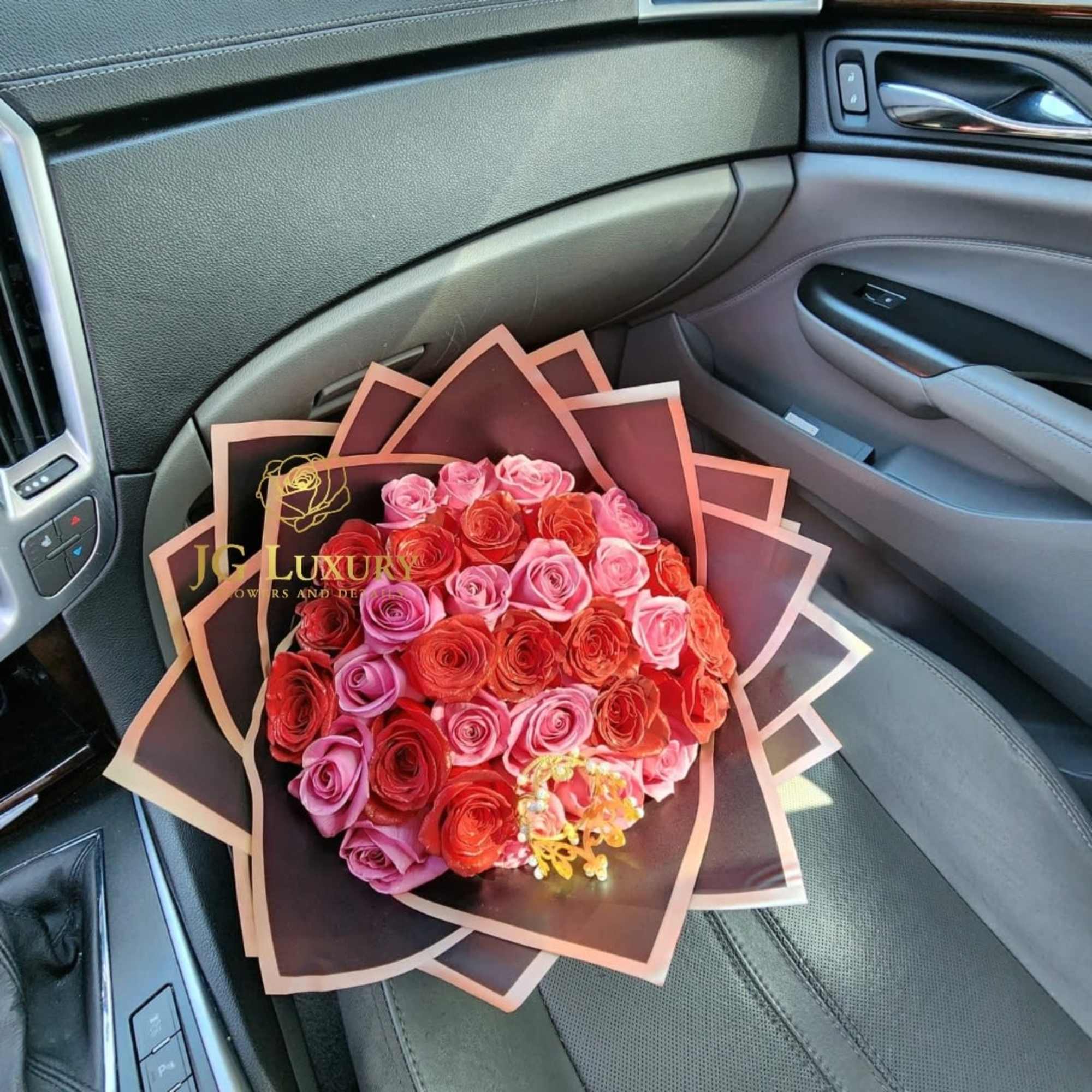 Two dozen of red and pink roses with a touch of royalty