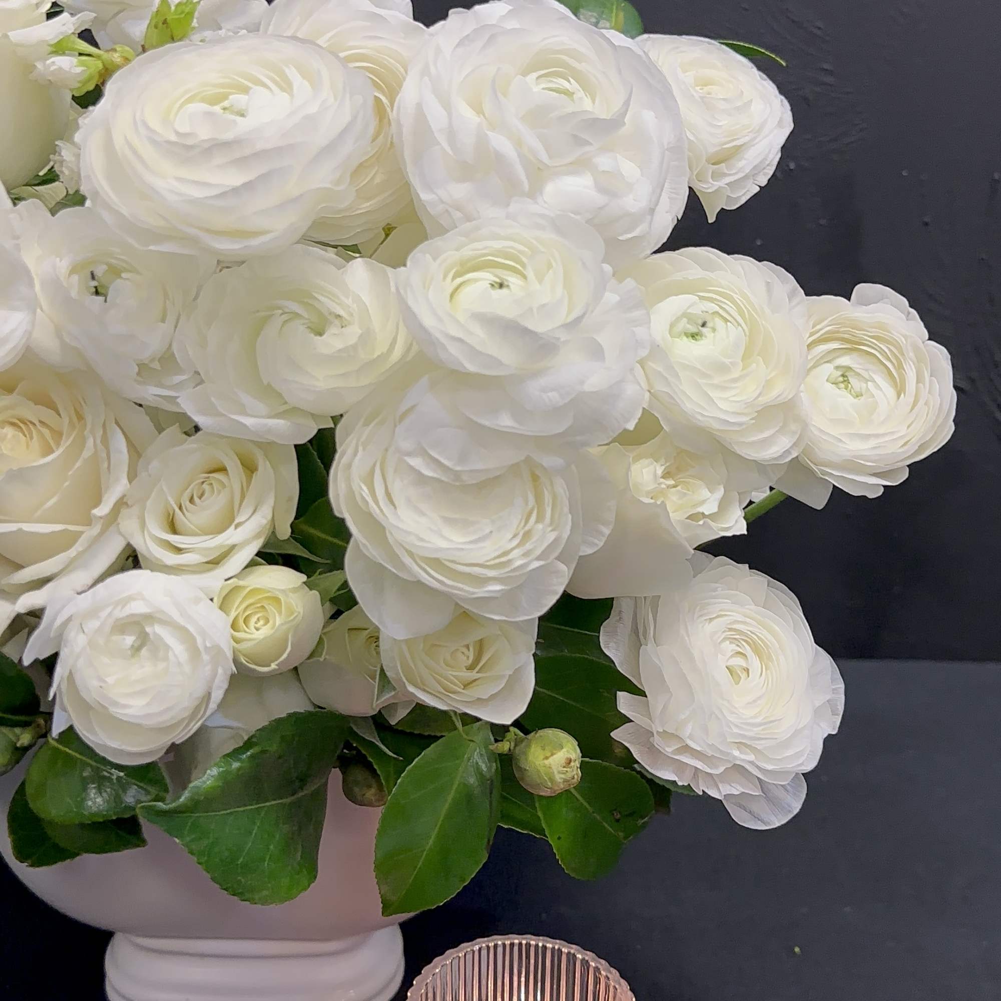 White Ranunculus, Blossoms, Roses, Camelia leaf in a white ceramic
