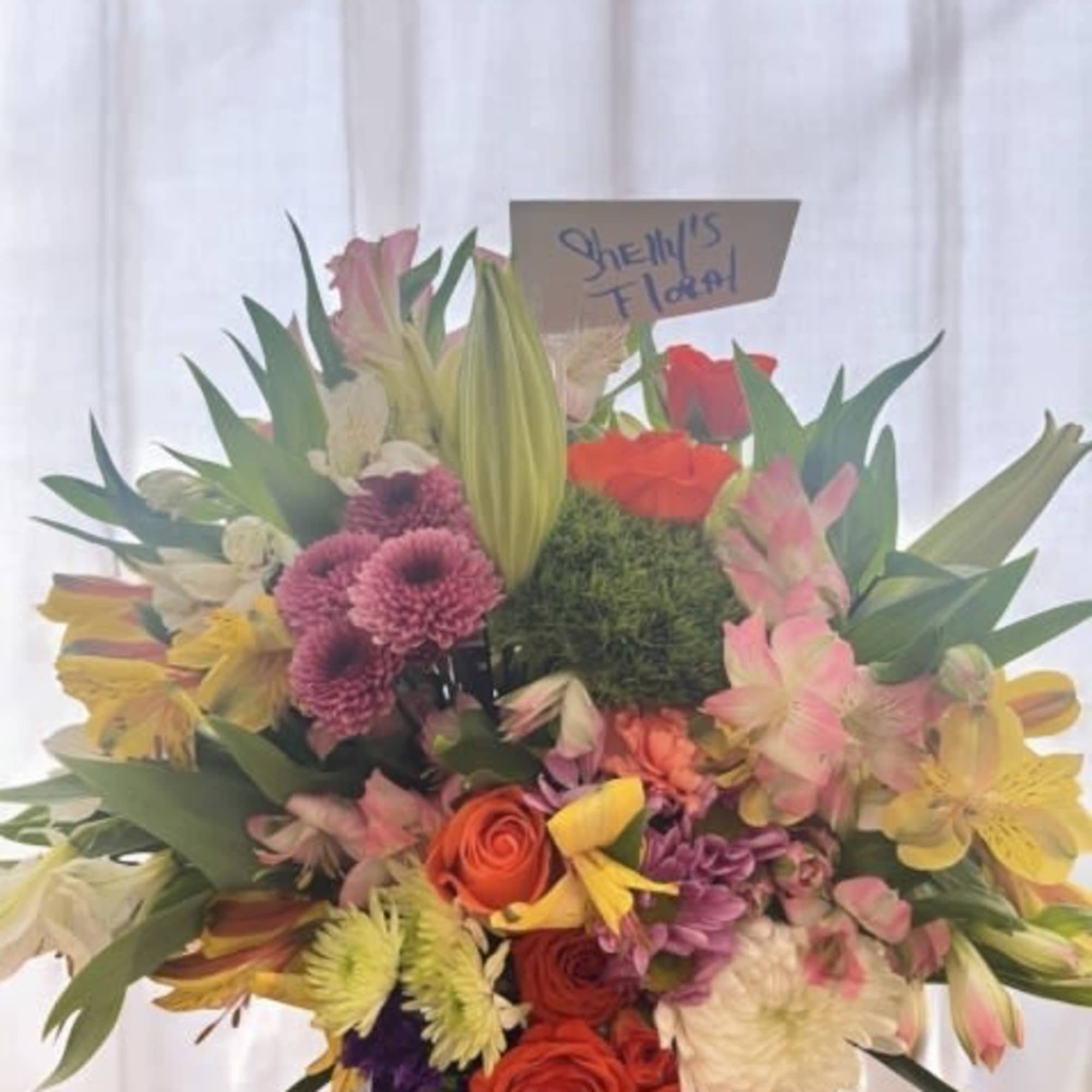  A lively burst of color and elegance, this arrangement is designed