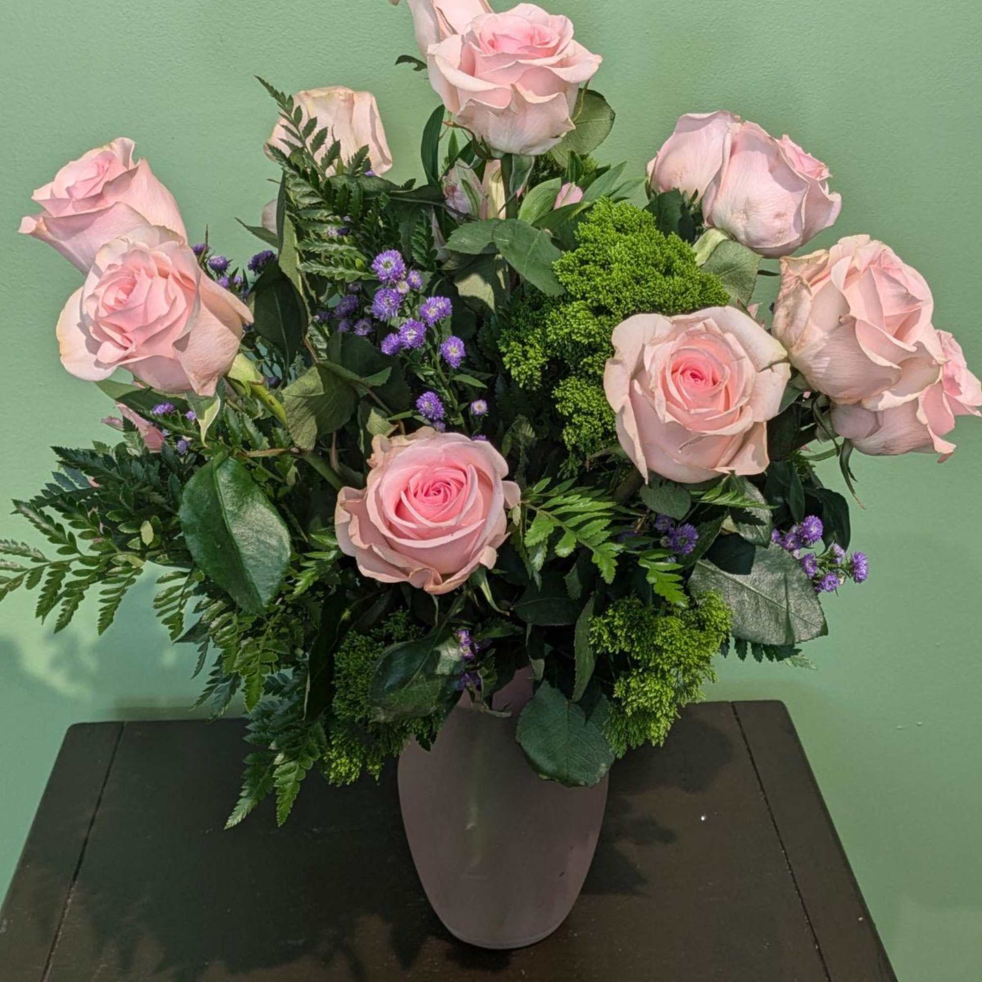 One dozen roses in a vase.

*Be aware that due to a global
