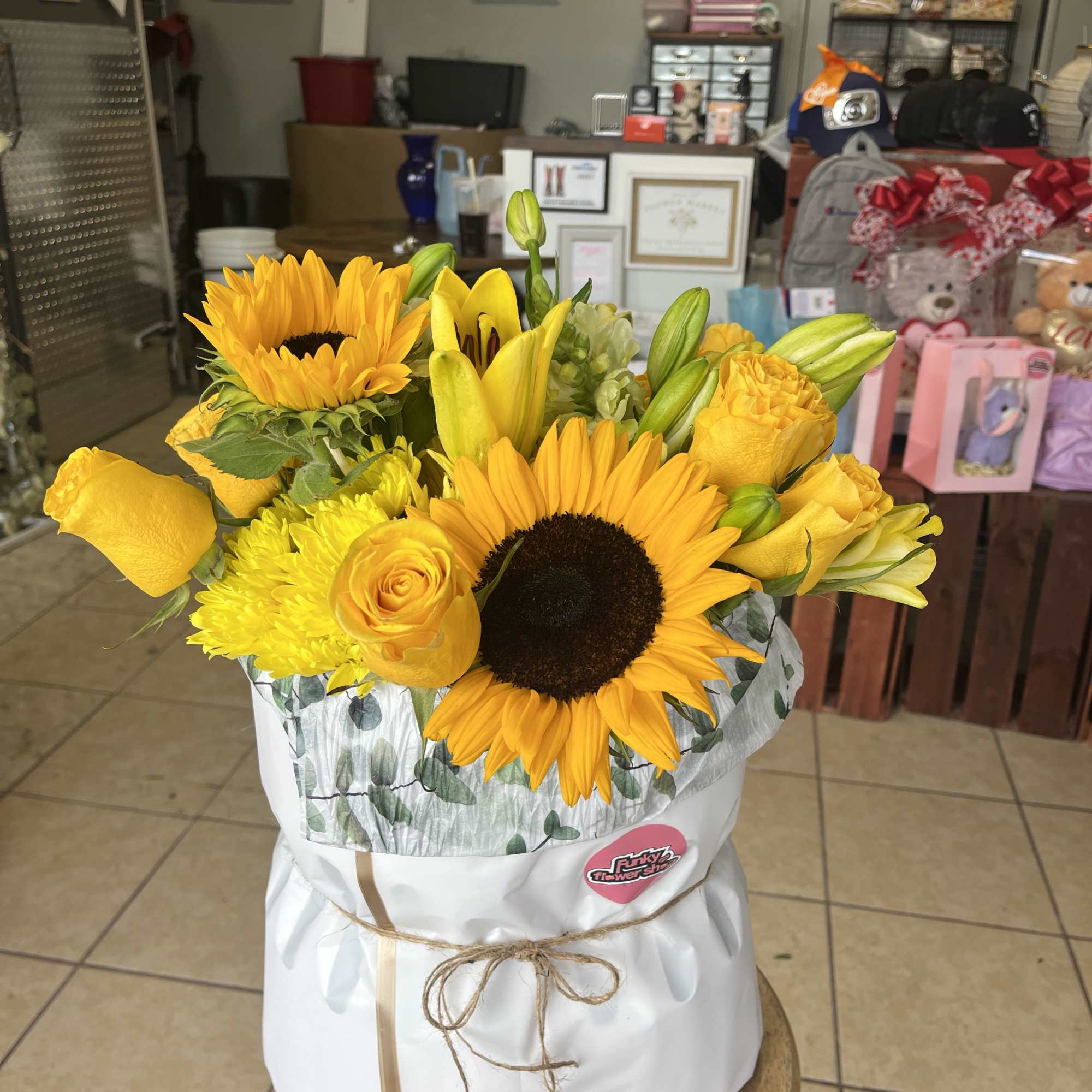 an assortment of yellow florals in a specialty bouquet wrap