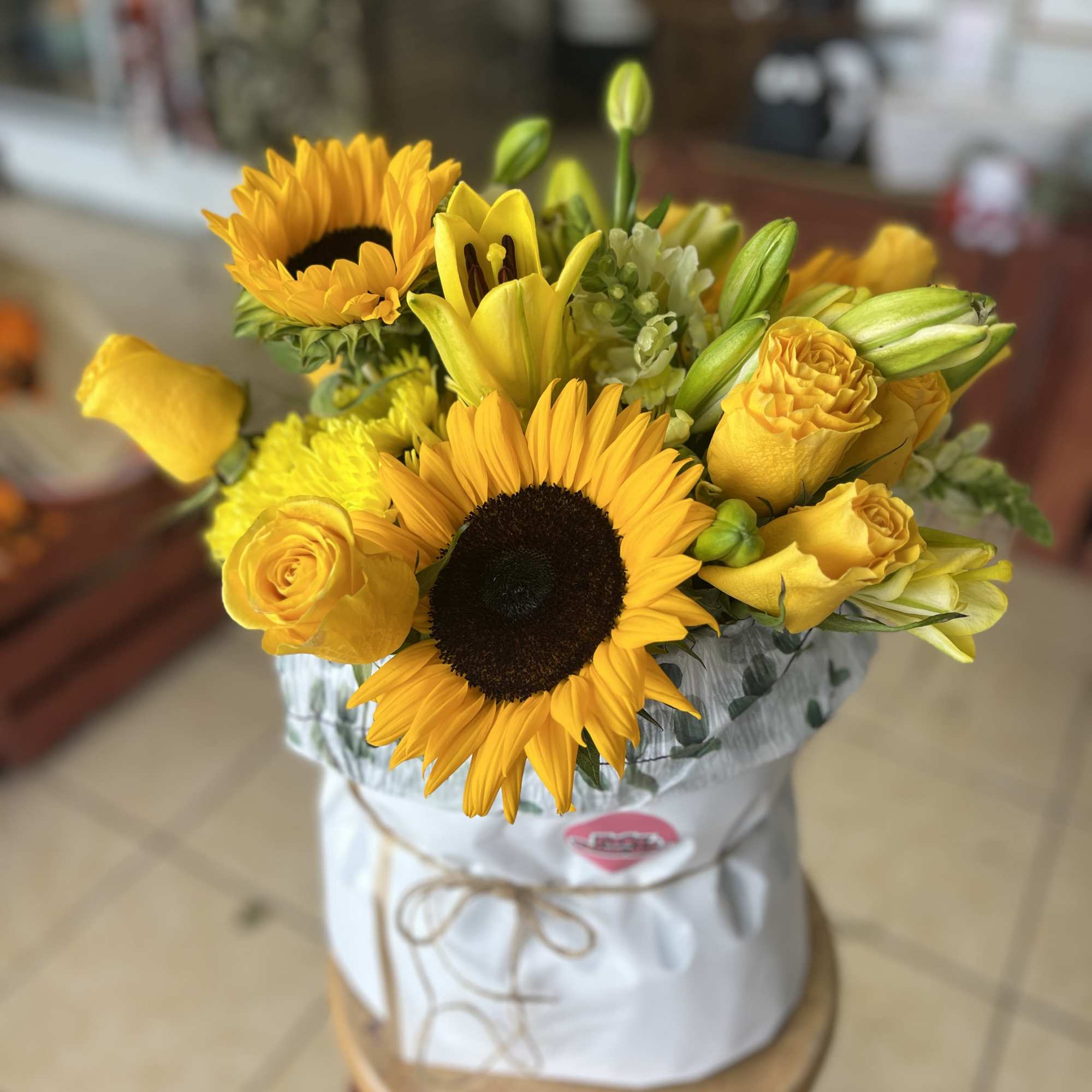 an assortment of yellow florals in a specialty bouquet wrap