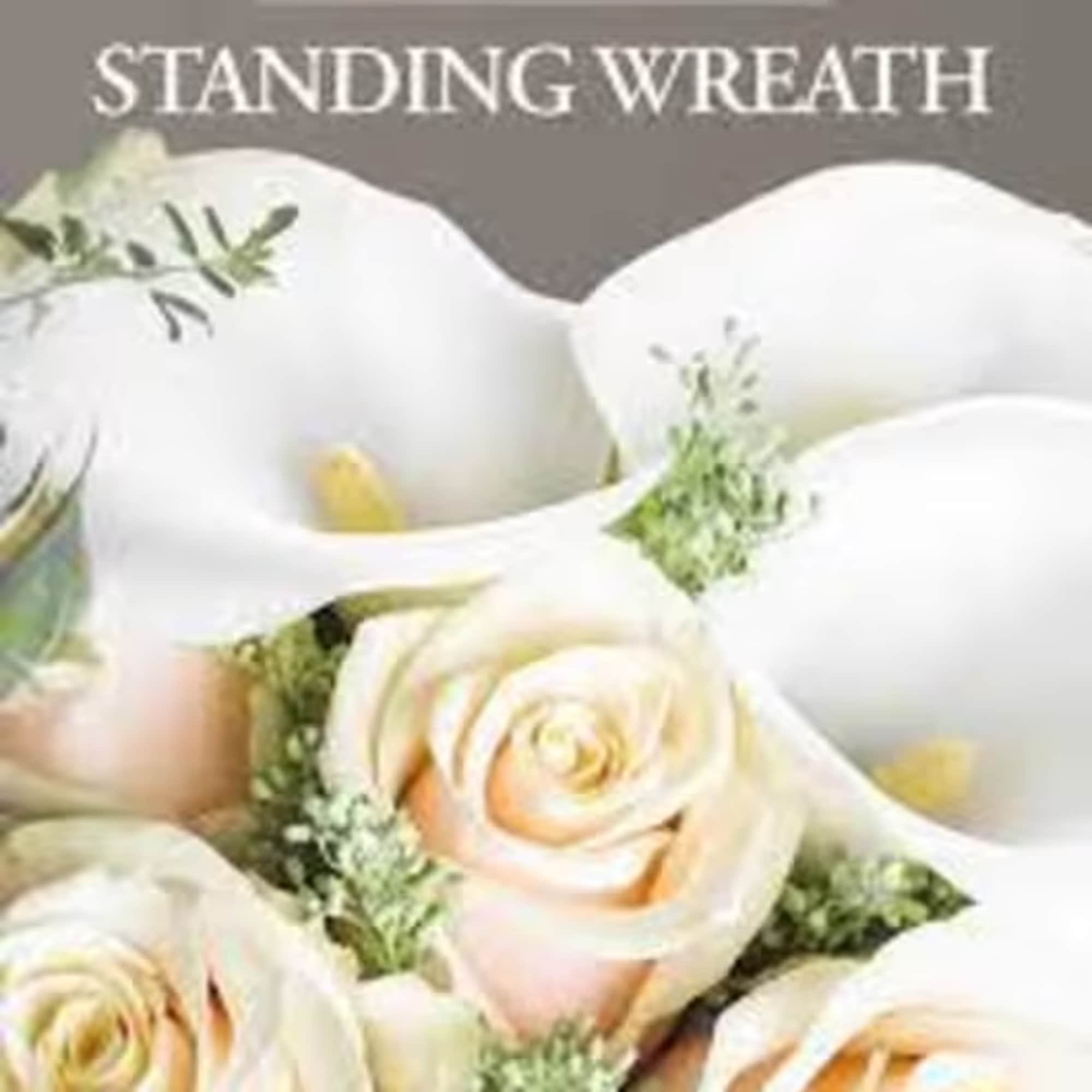 An elegant tribute for a loved one, softly colored roses, lilies, alstroemeria