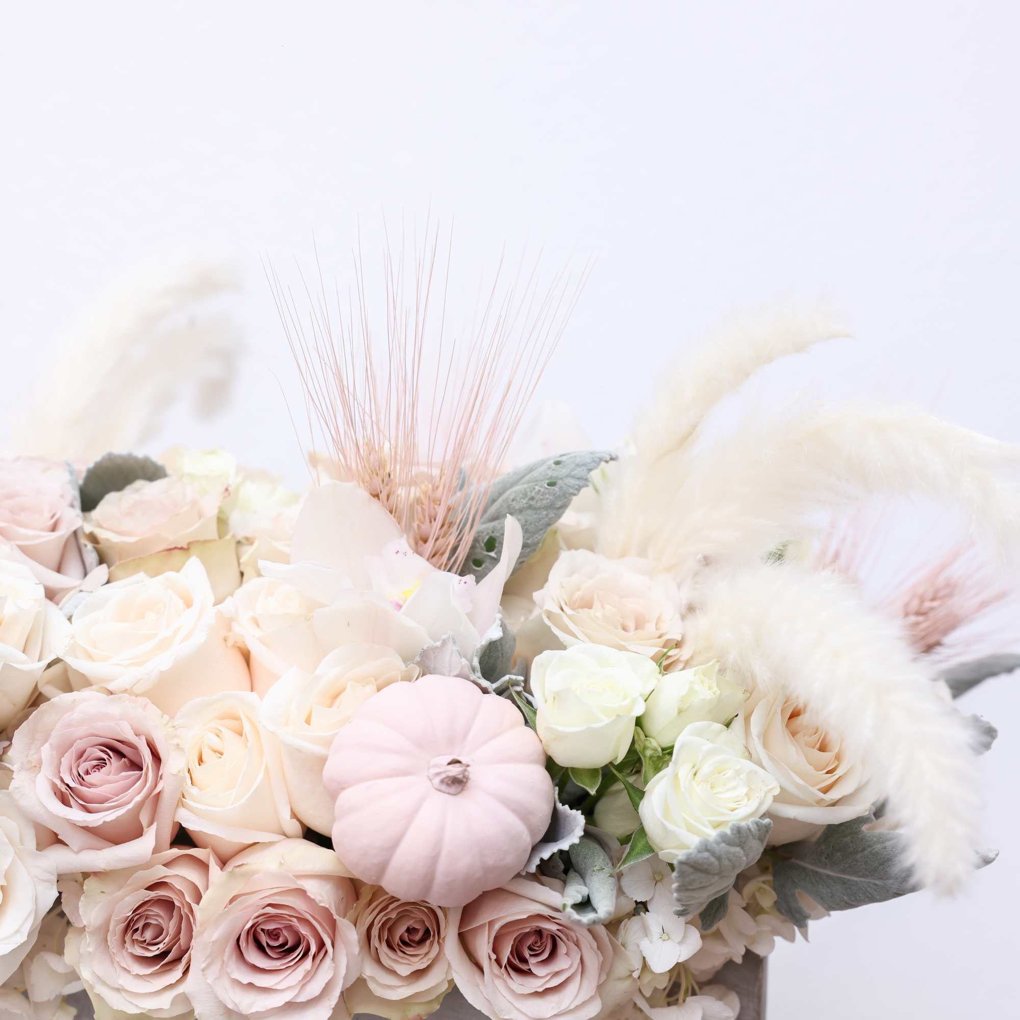 The arrangement comes in a long clay vases with the following florals;