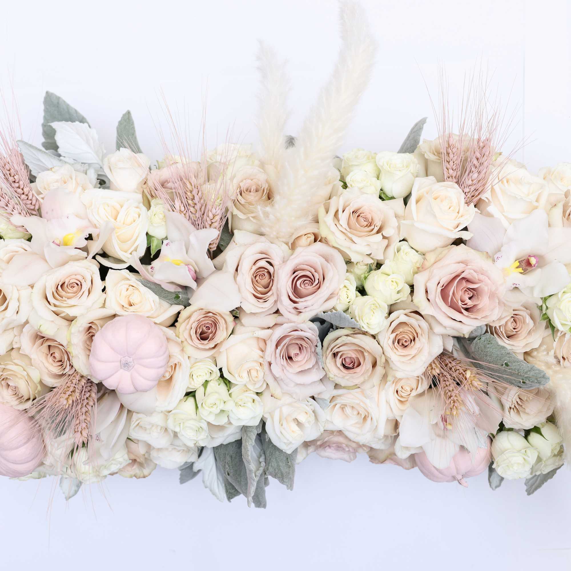 The arrangement comes in a long clay vases with the following florals;