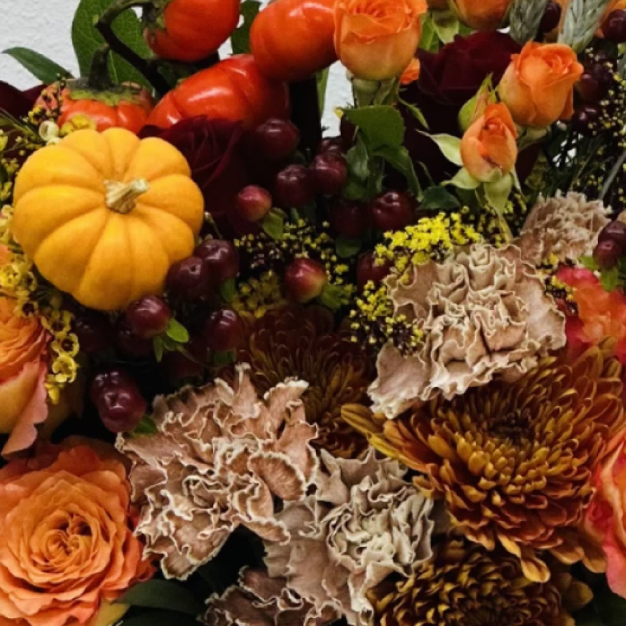Invite fall beauty to the table with elegant arrangement, presented in a
