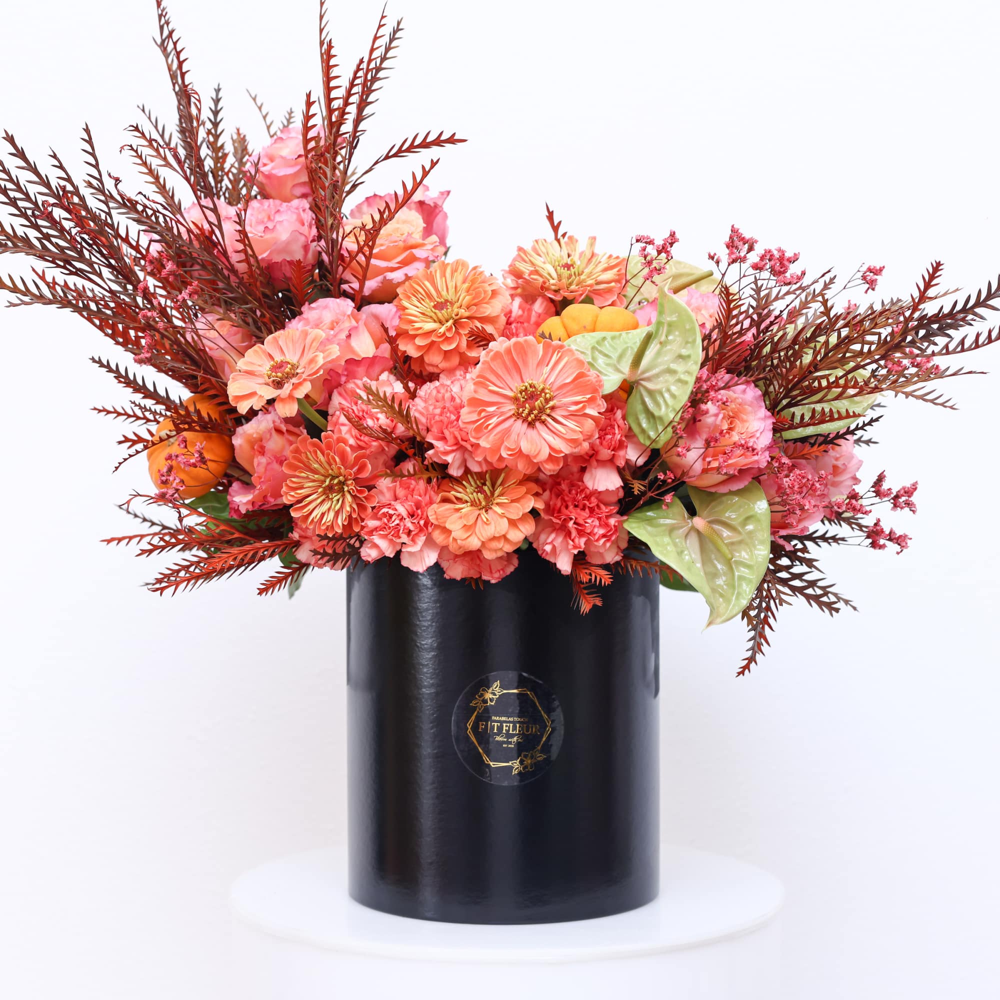 The arrangement has the following florals; Free spirit, Zinnia and pumpkin decor.