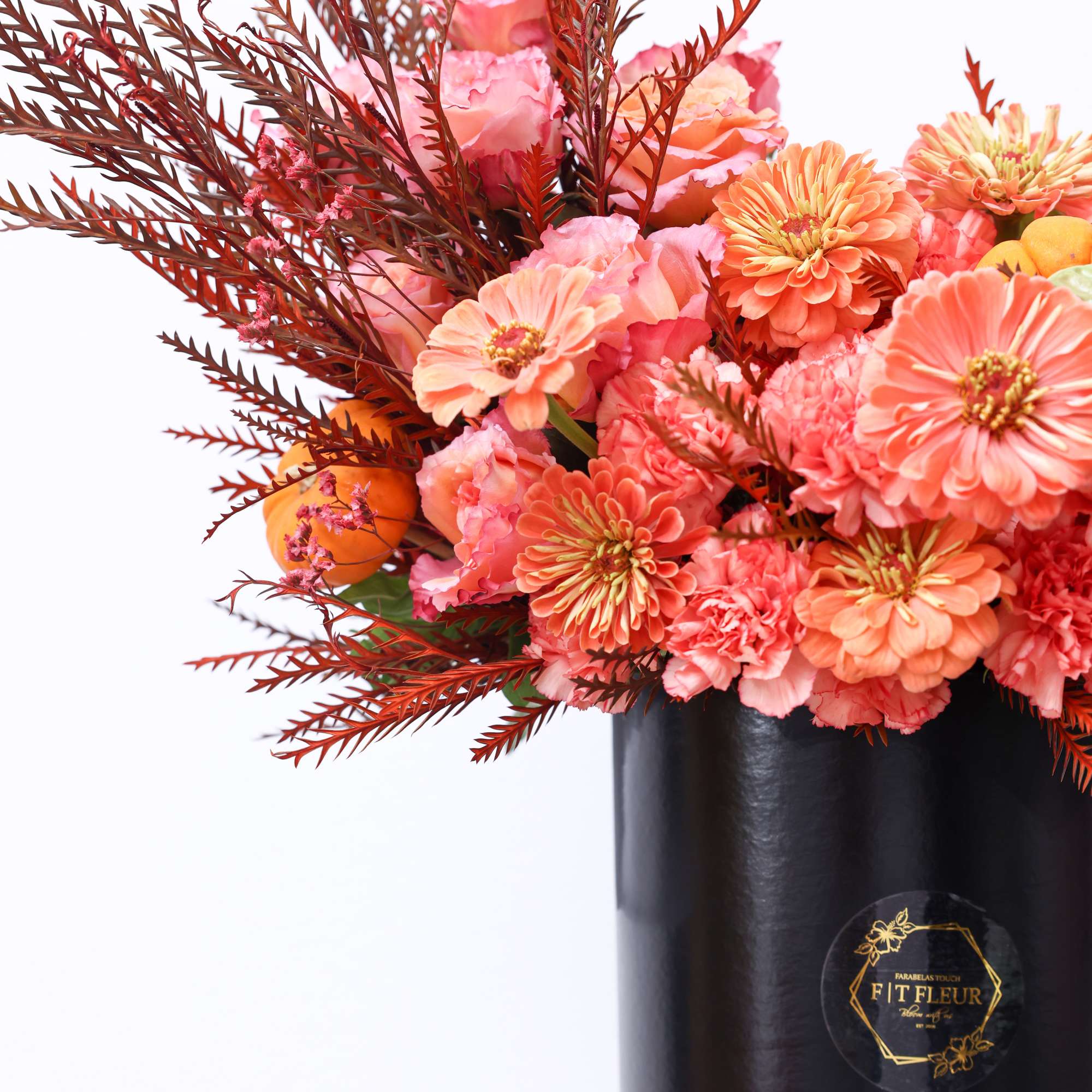 The arrangement has the following florals; Free spirit, Zinnia and pumpkin decor.