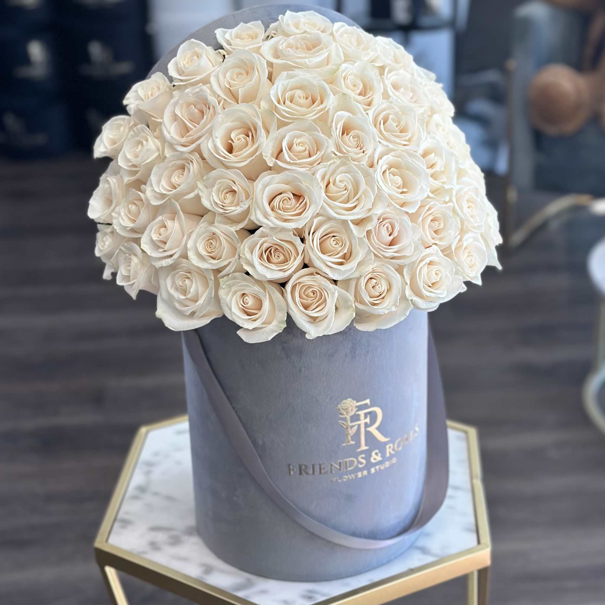 Our signature gray box, filled with 50 fresh-cut white roses, is a
