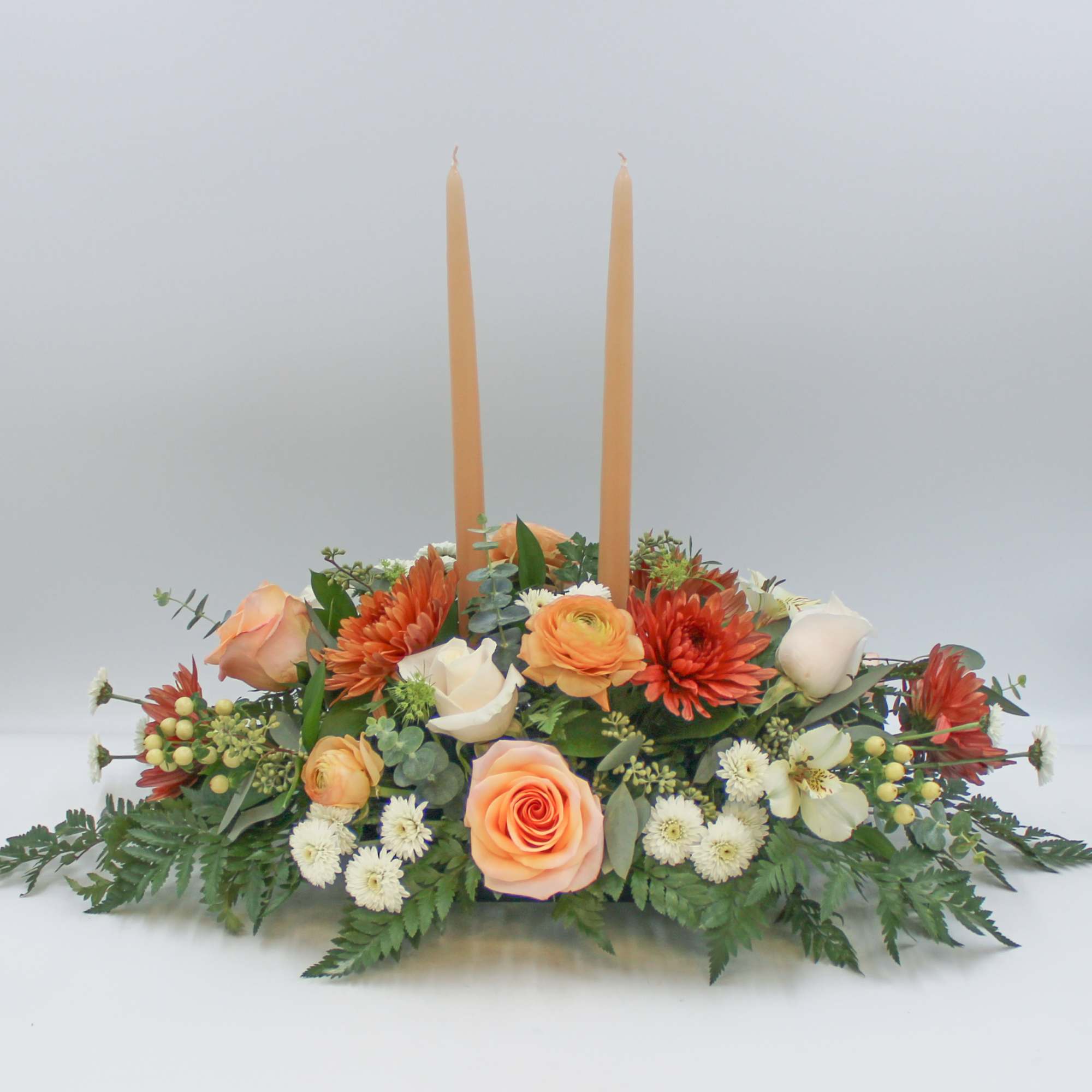 Ginger Spice is a traditional long and low centerpiece with beautiful Peach