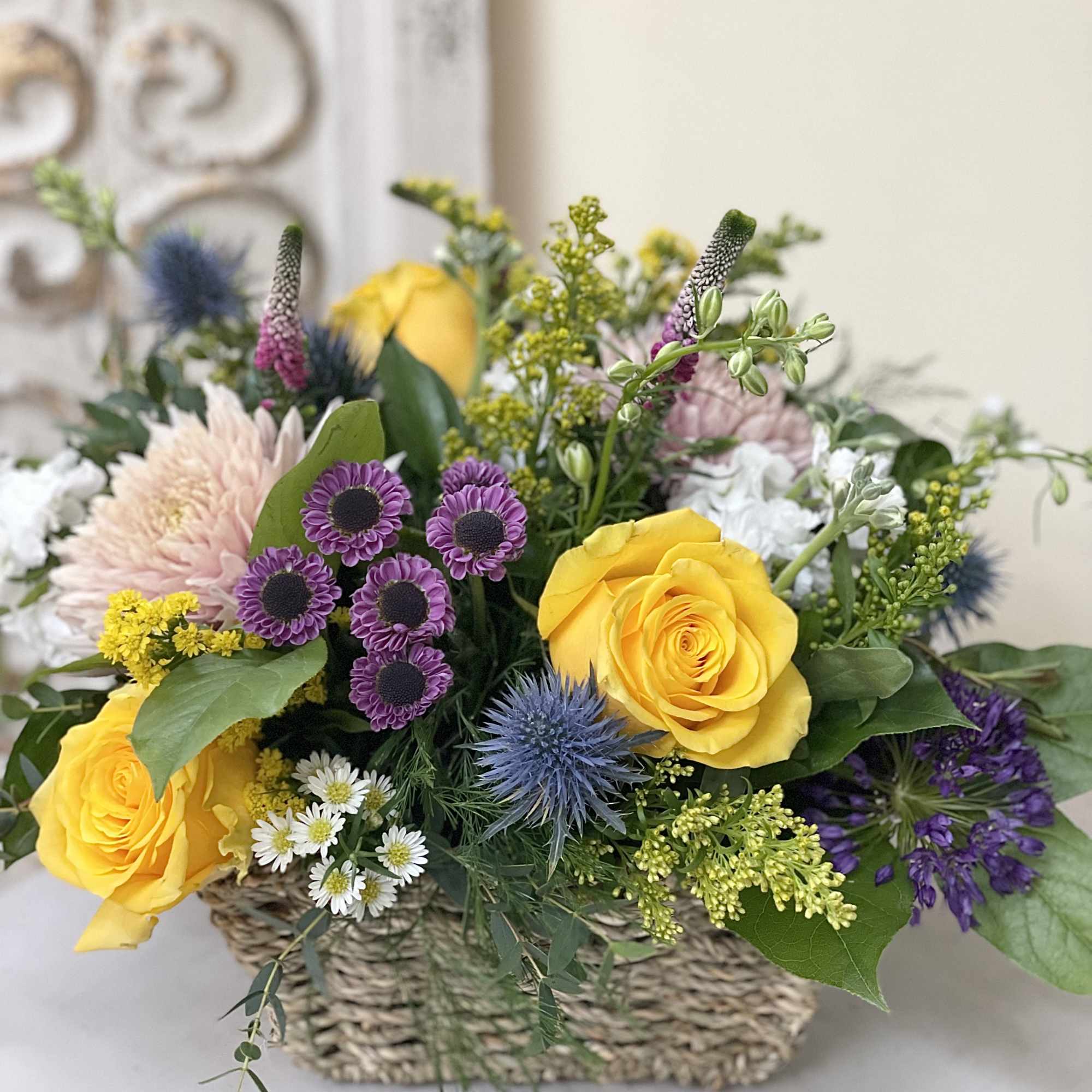 A basket brimming with seasonal blooms and greens.