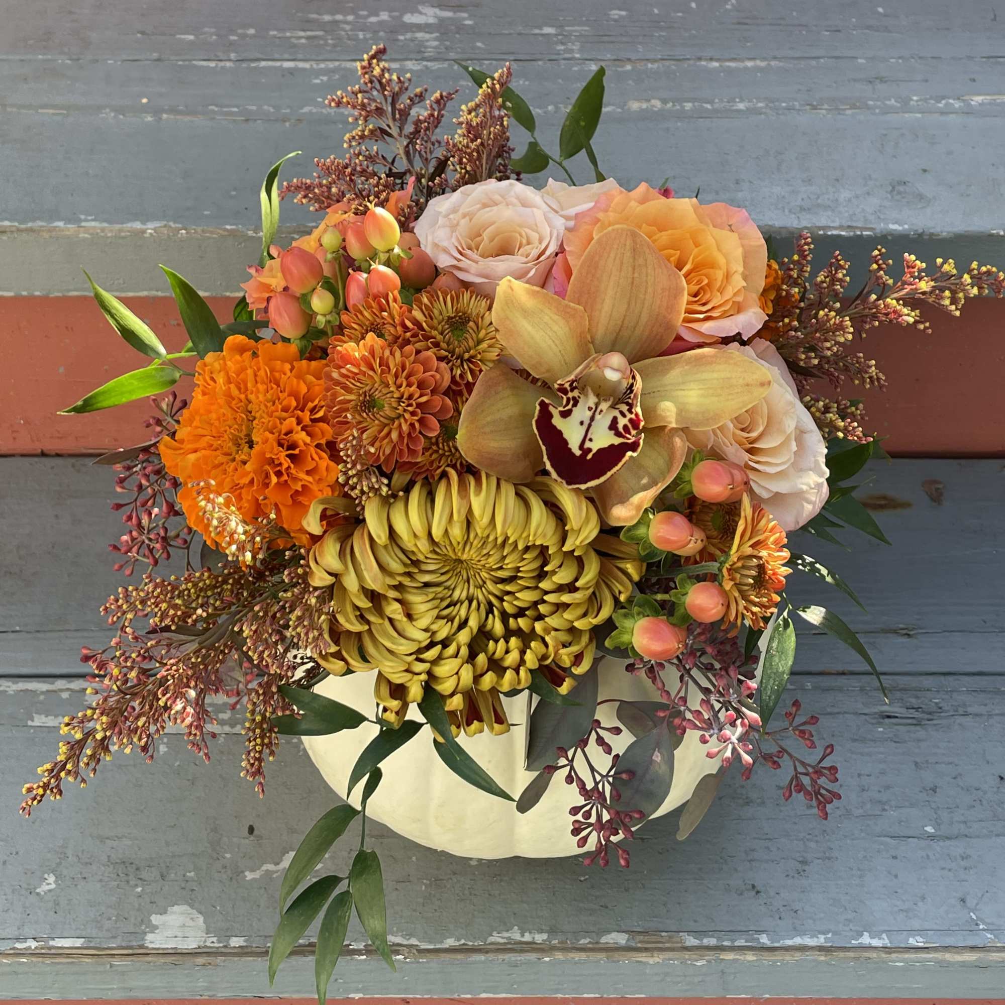 Celebrate the season with this lovely fall arrangement. A small white pumpkin Celebrate the season with this lovely fall arrangement. A small white pumpkin