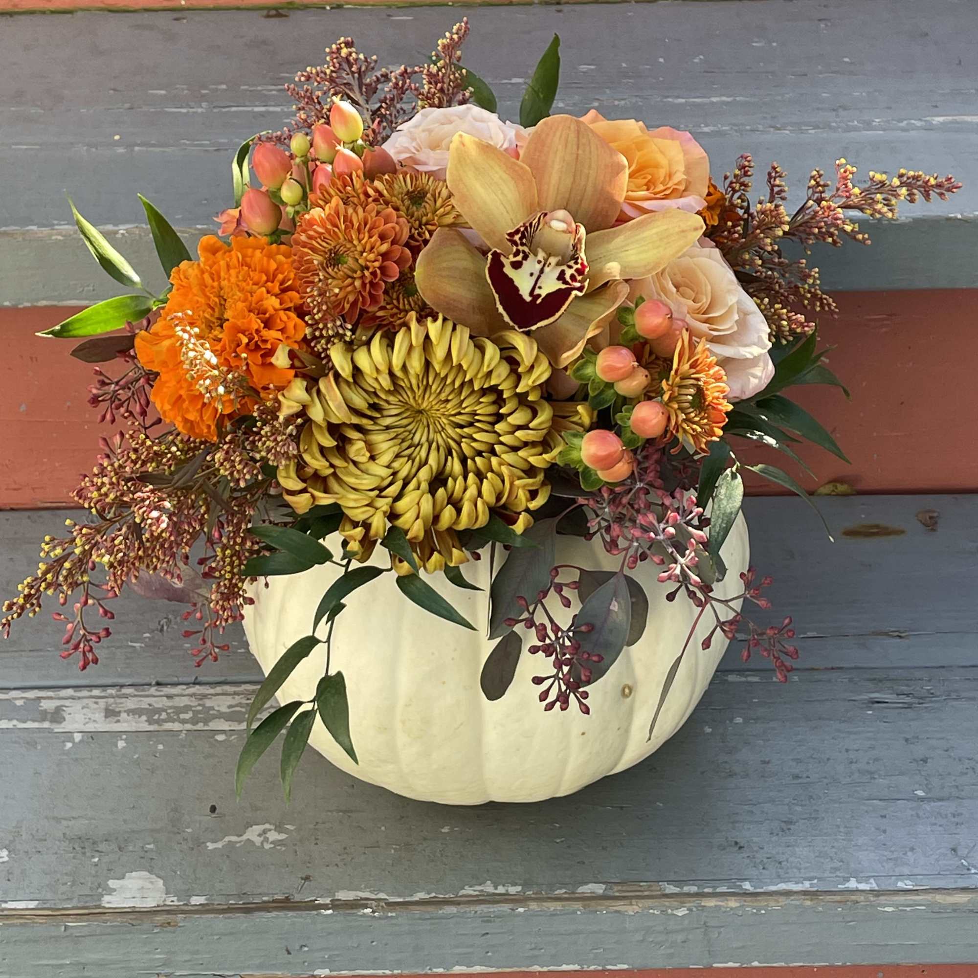 Celebrate the season with this lovely fall arrangement. A small white pumpkin Celebrate the season with this lovely fall arrangement. A small white pumpkin
