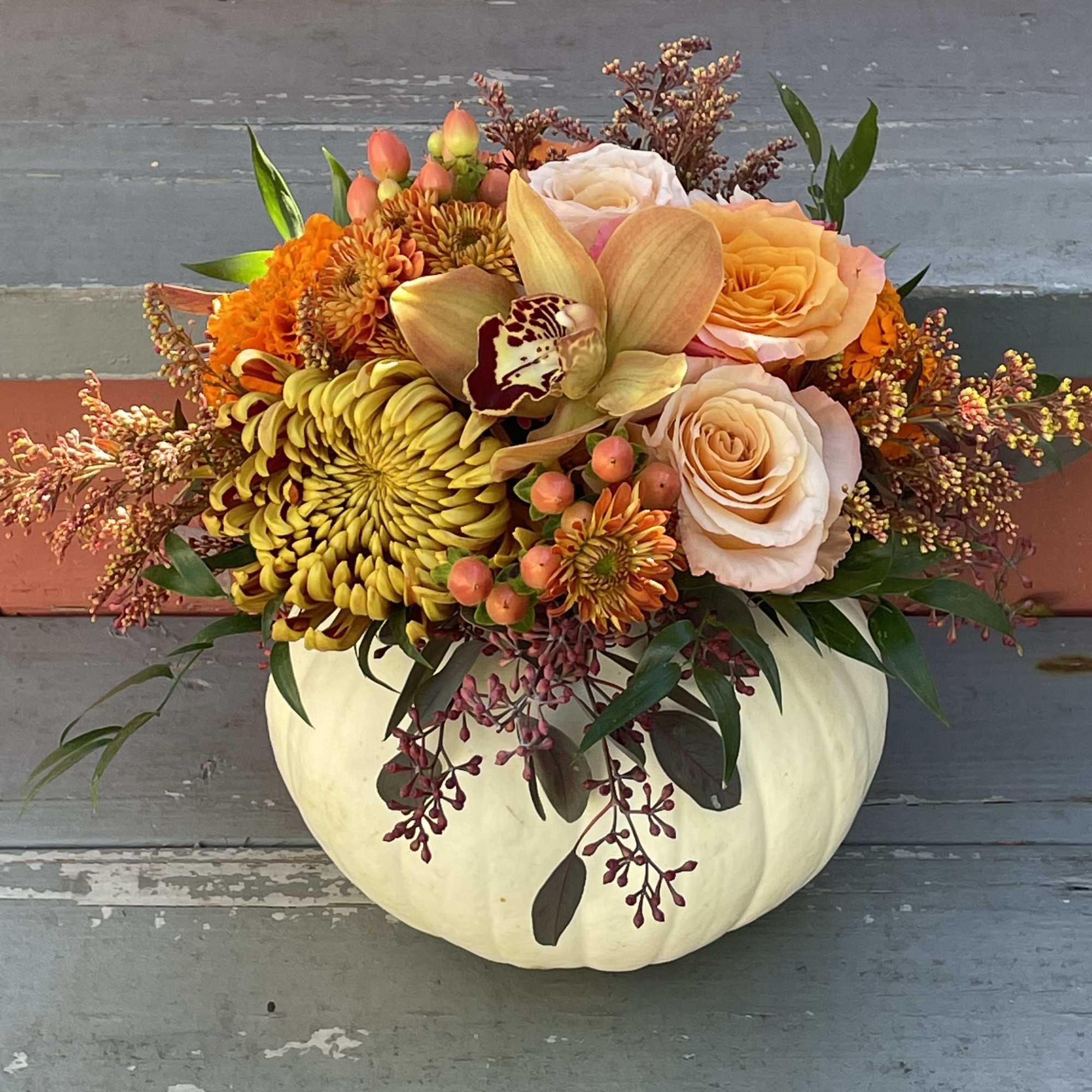 Celebrate the season with this lovely fall arrangement. A small white pumpkin Celebrate the season with this lovely fall arrangement. A small white pumpkin