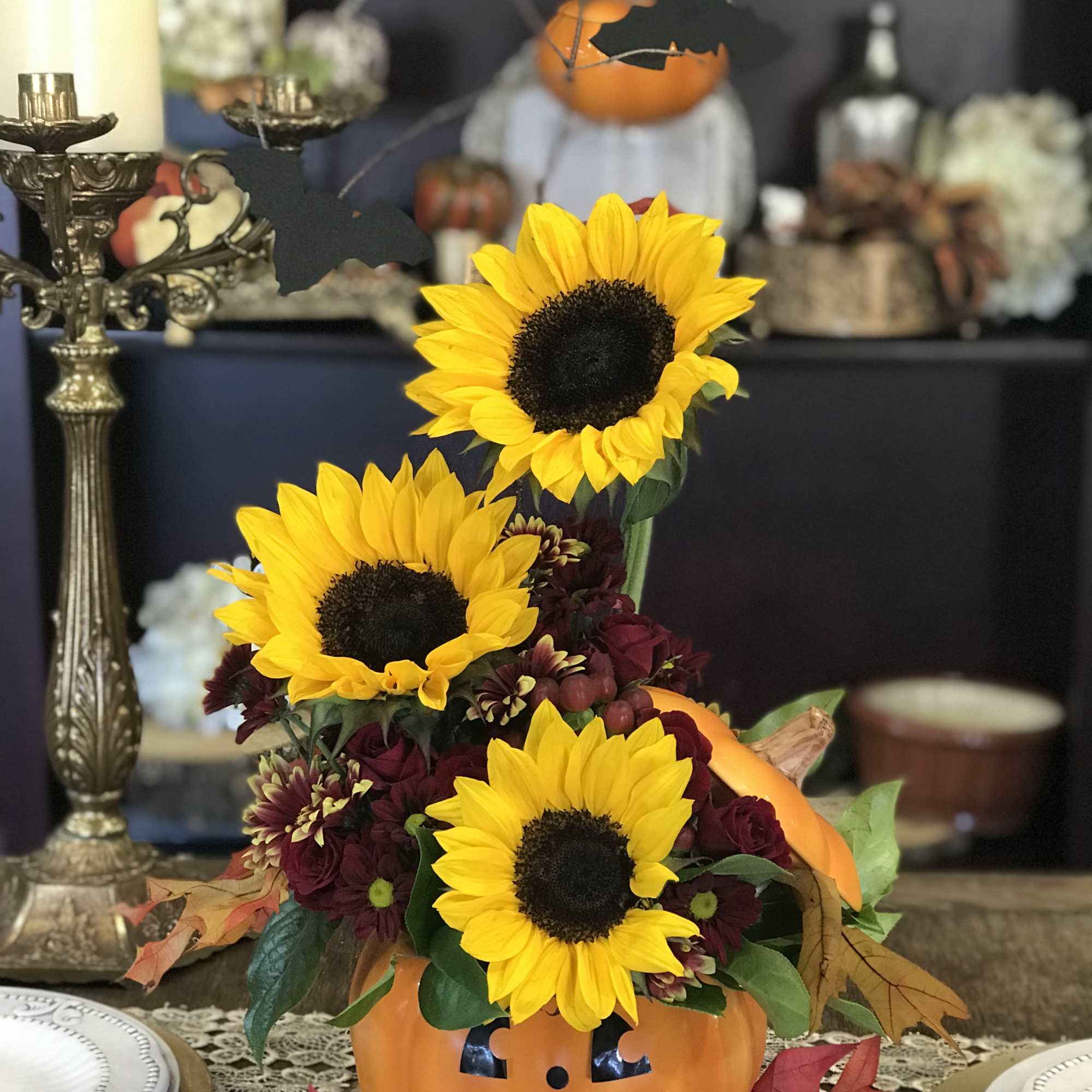A ceramic Cookie Jar pumpkin with sunflowers, daisies and spray roses and A ceramic Cookie Jar pumpkin with sunflowers, daisies and spray roses and