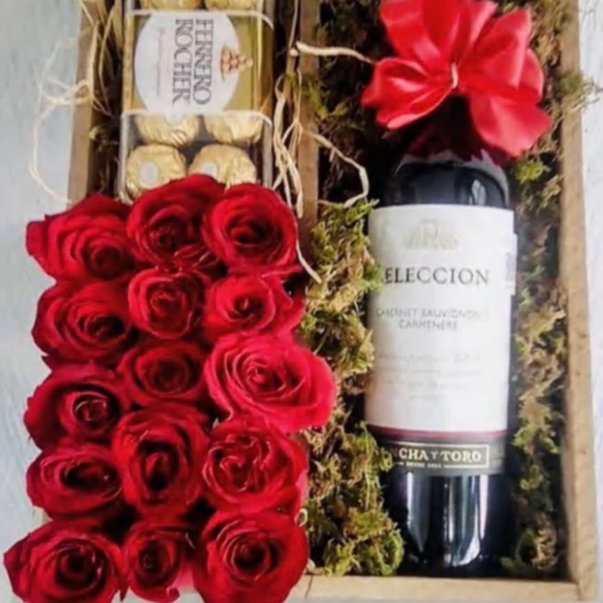 Beautiful arrangement with 12 roses, chocolates and a bottle of wine. Beautiful arrangement with 12 roses, chocolates and a bottle of wine.