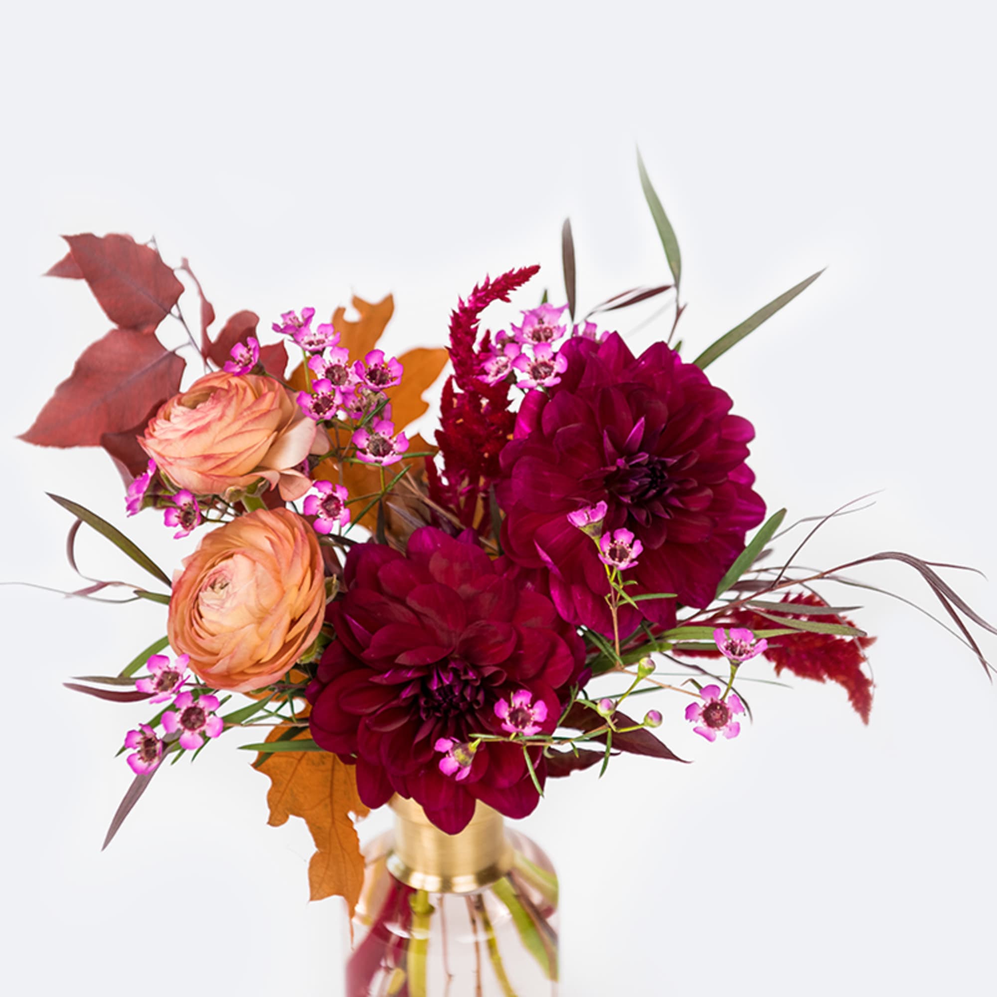 A variety of beautiful autumn blooms and foliage in mixed heights arranged