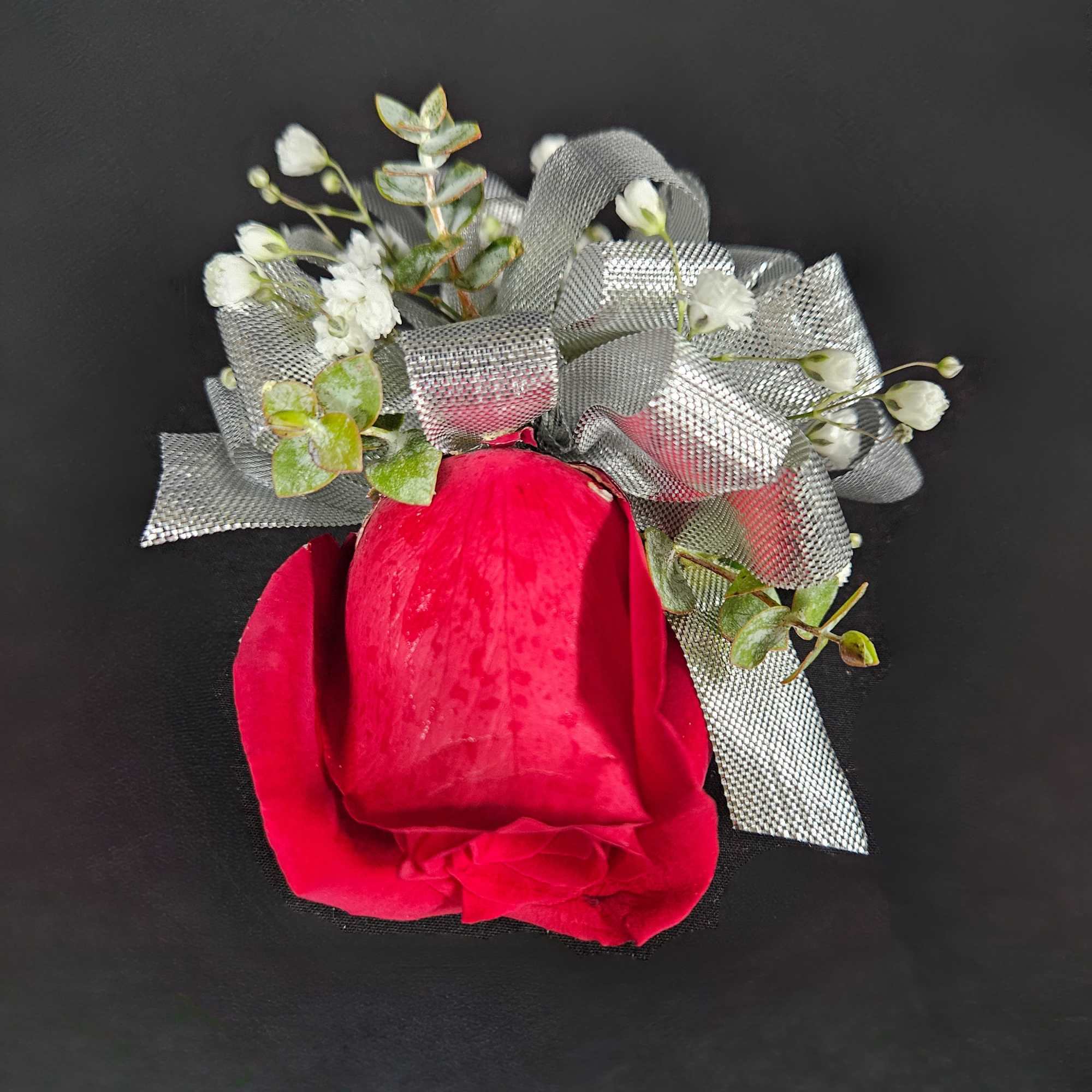 A beautiful rose corsage with ribbon and babies breath. Available in White A beautiful rose corsage with ribbon and babies breath. Available in White