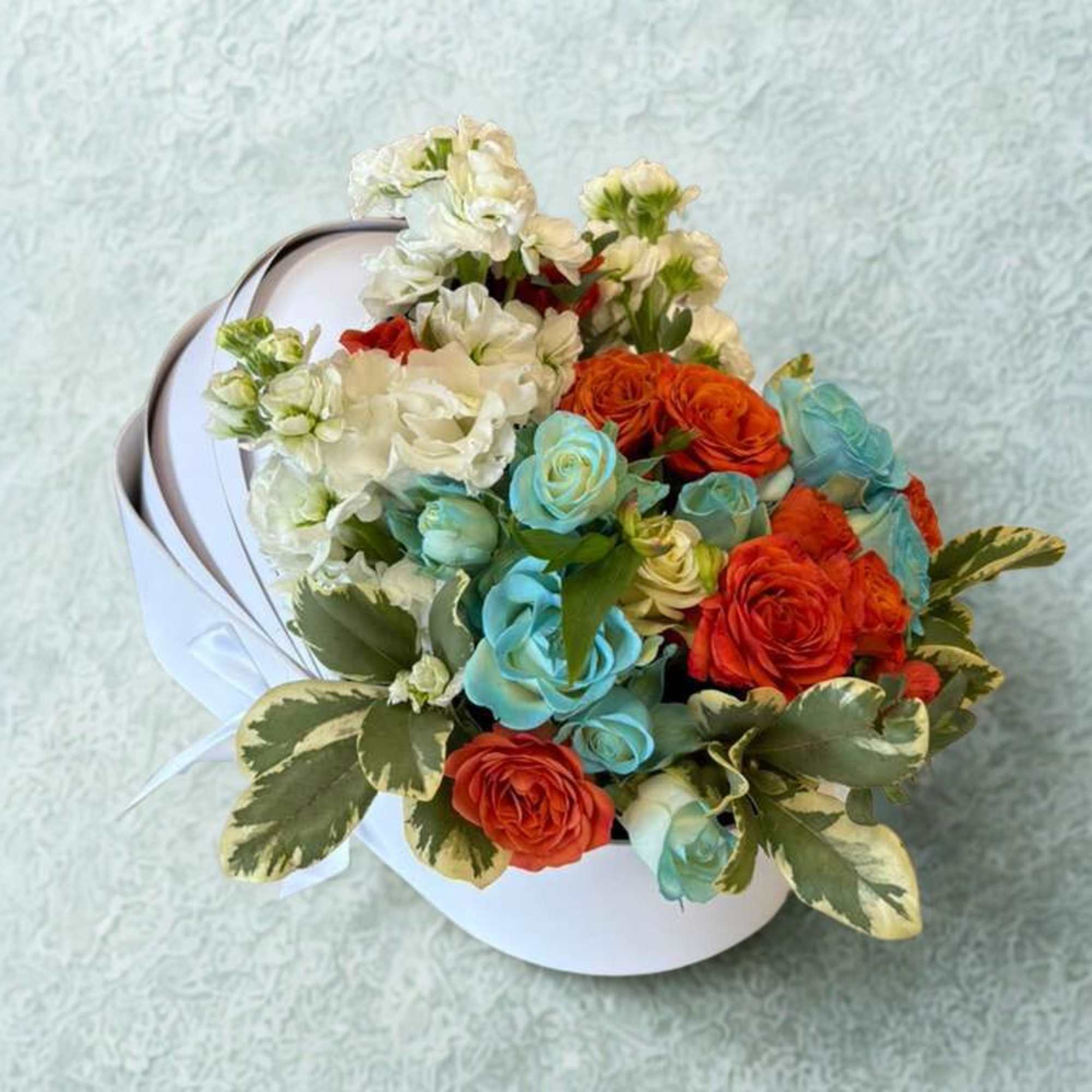 Celebrate the arrival of your baby with this tender arrangement in shades