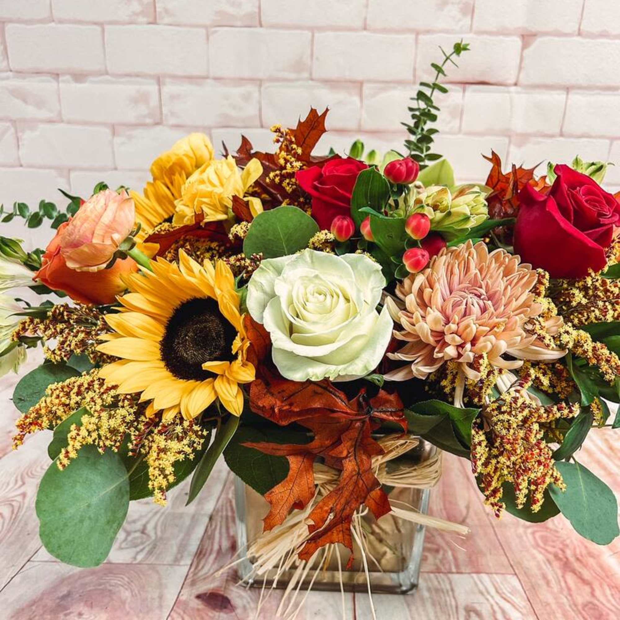 Autumn blooms and greens especially for fall. This arrangement brings an elegant