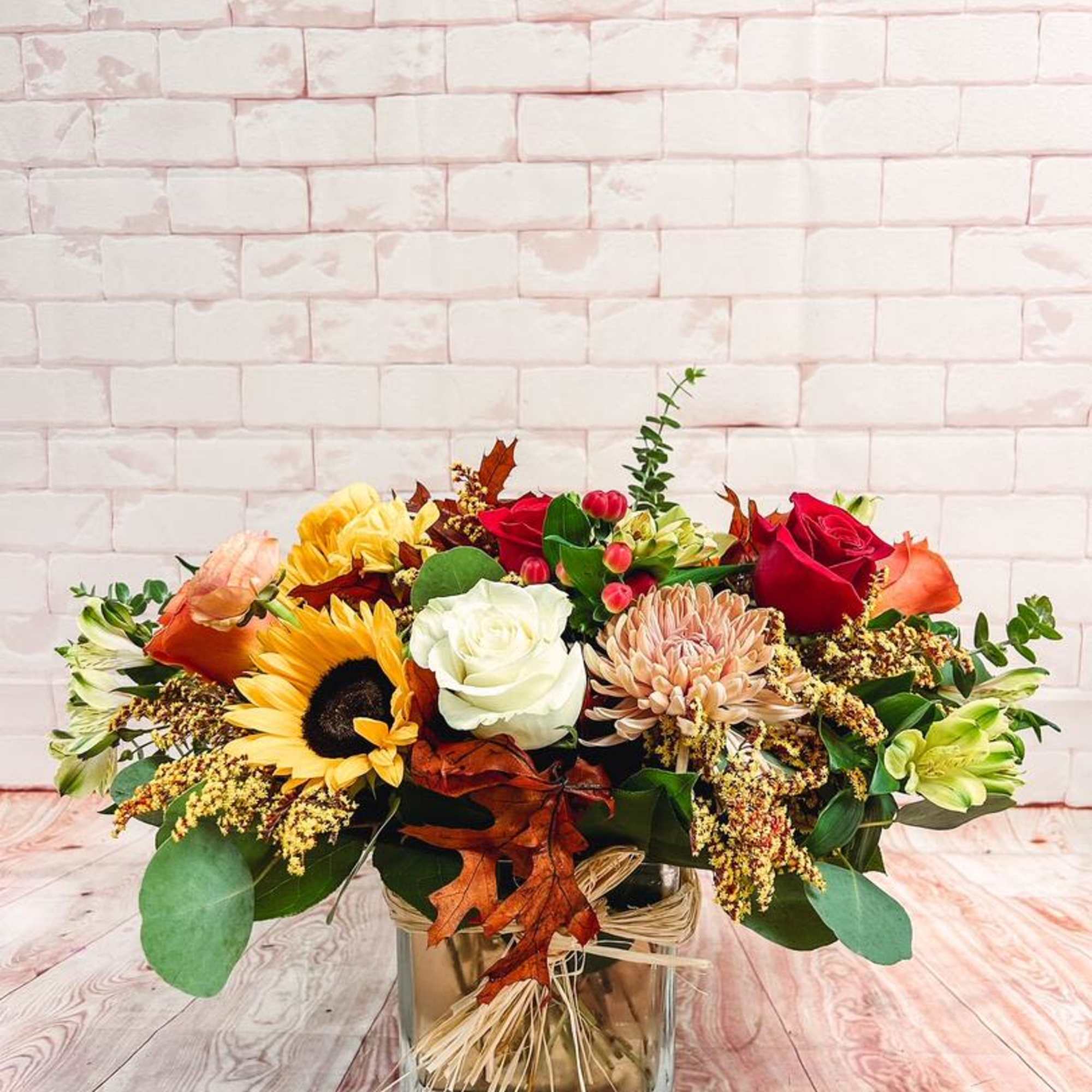 Autumn blooms and greens especially for fall. This arrangement brings an elegant