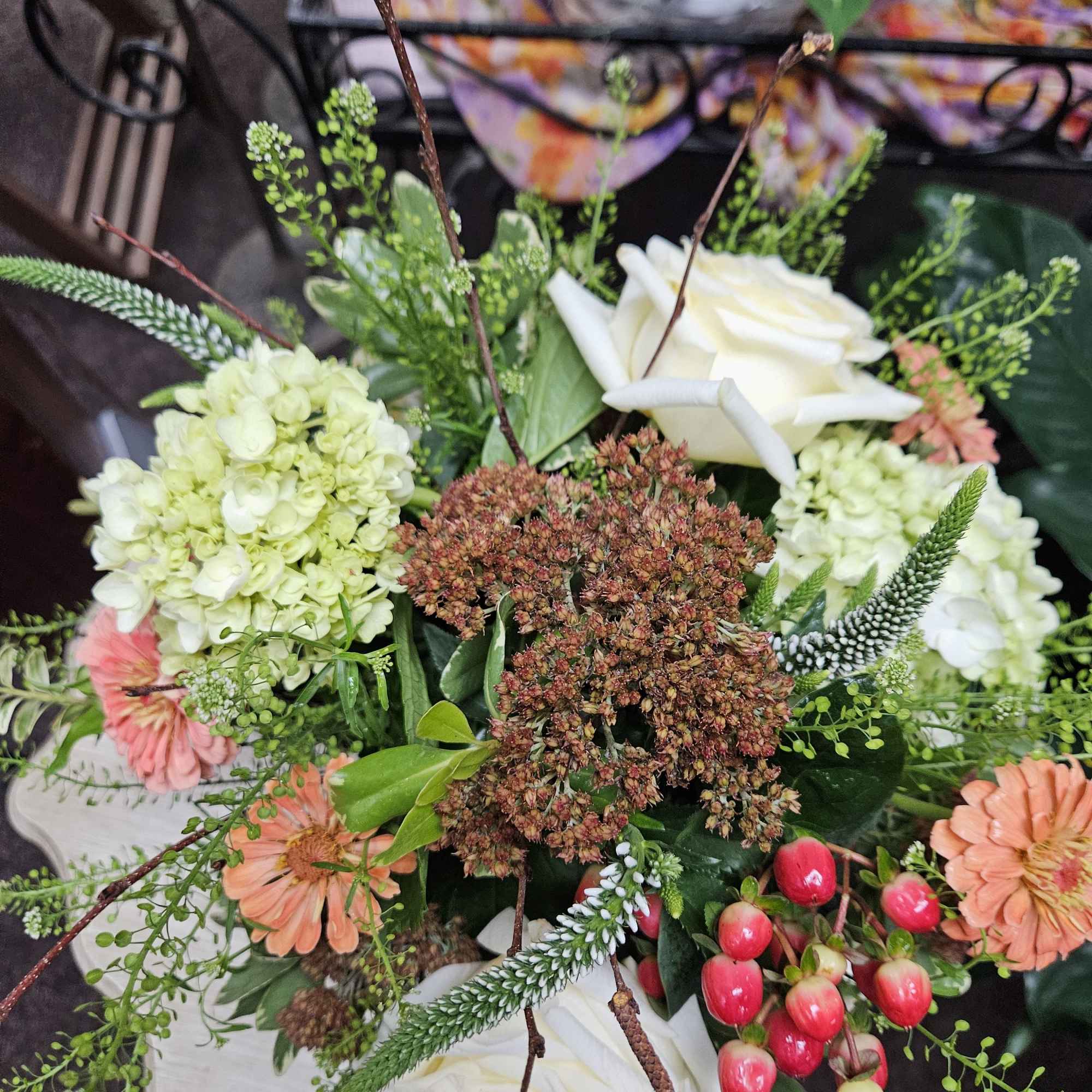 Mix of candlelight roses, autumn joy (Sedum), peach hypericum berries, natural zinnias Mix of candlelight roses, autumn joy (Sedum), peach hypericum berries, natural zinnias