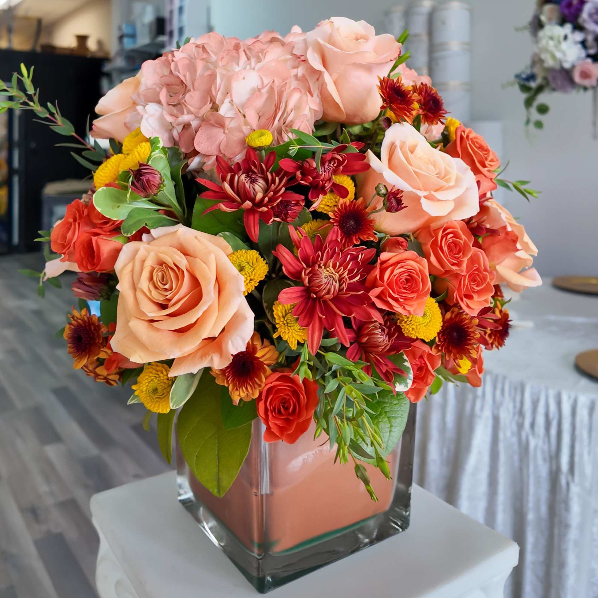 Includes Hydrangeas, Orange roses, Orange spray roses, Orange pom cushion, Orange Pom Includes Hydrangeas, Orange roses, Orange spray roses, Orange pom cushion, Orange Pom