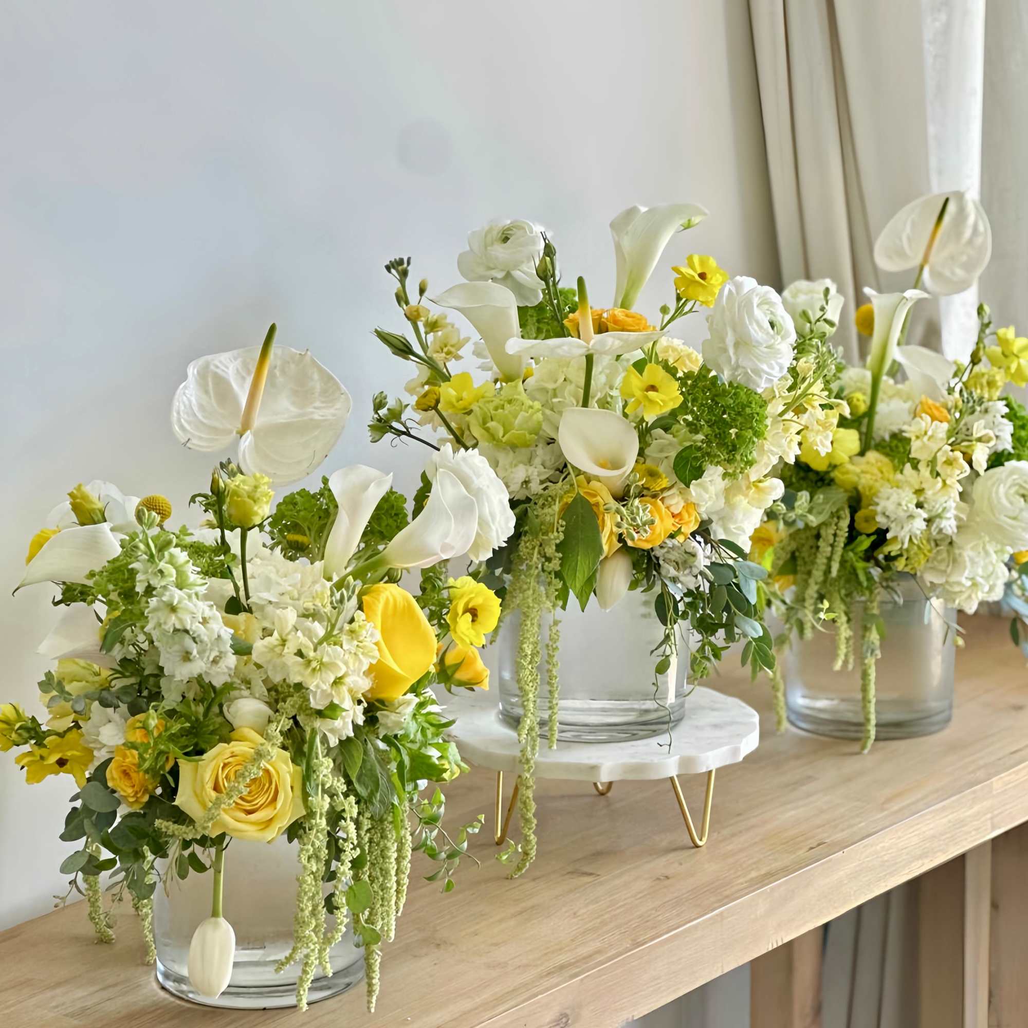 A fresh arrangement of white and yellow flowers arranged in a clear