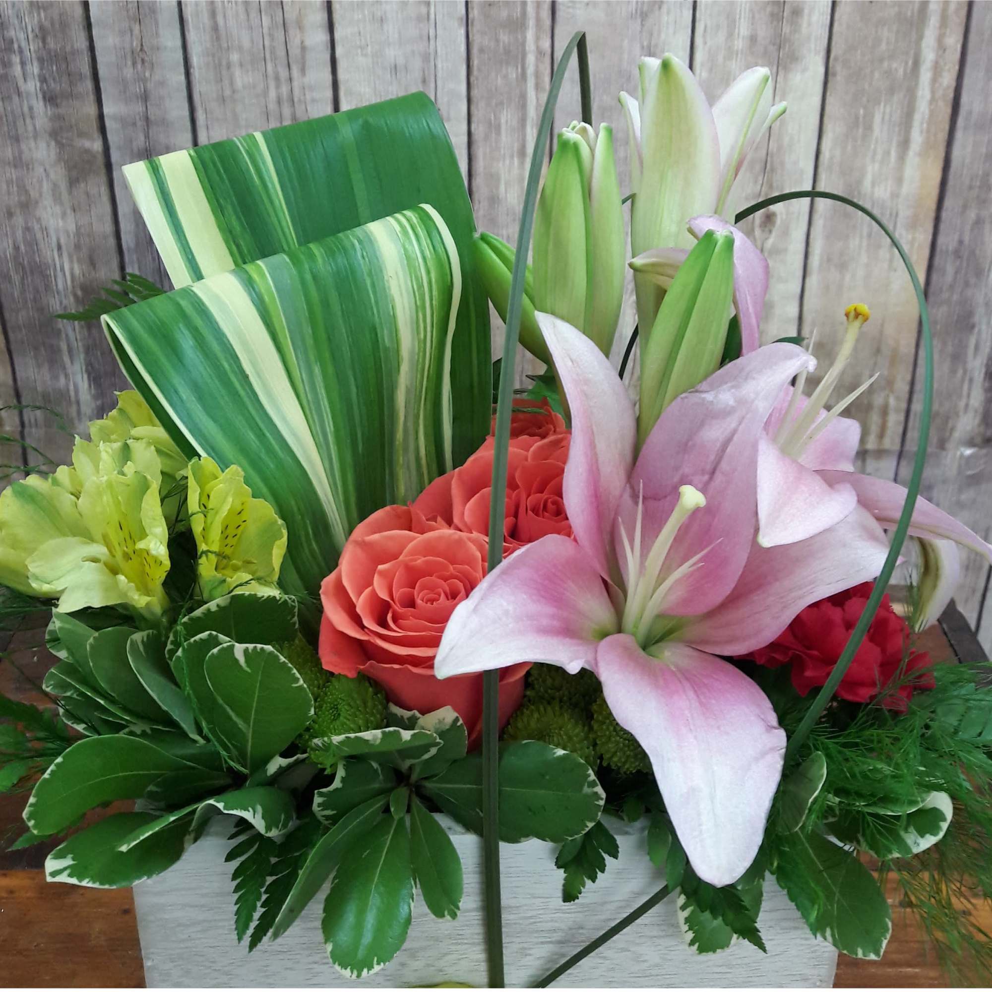 Send her a rainbow! lilies, radiant roses and regal Peruvian lilies burst