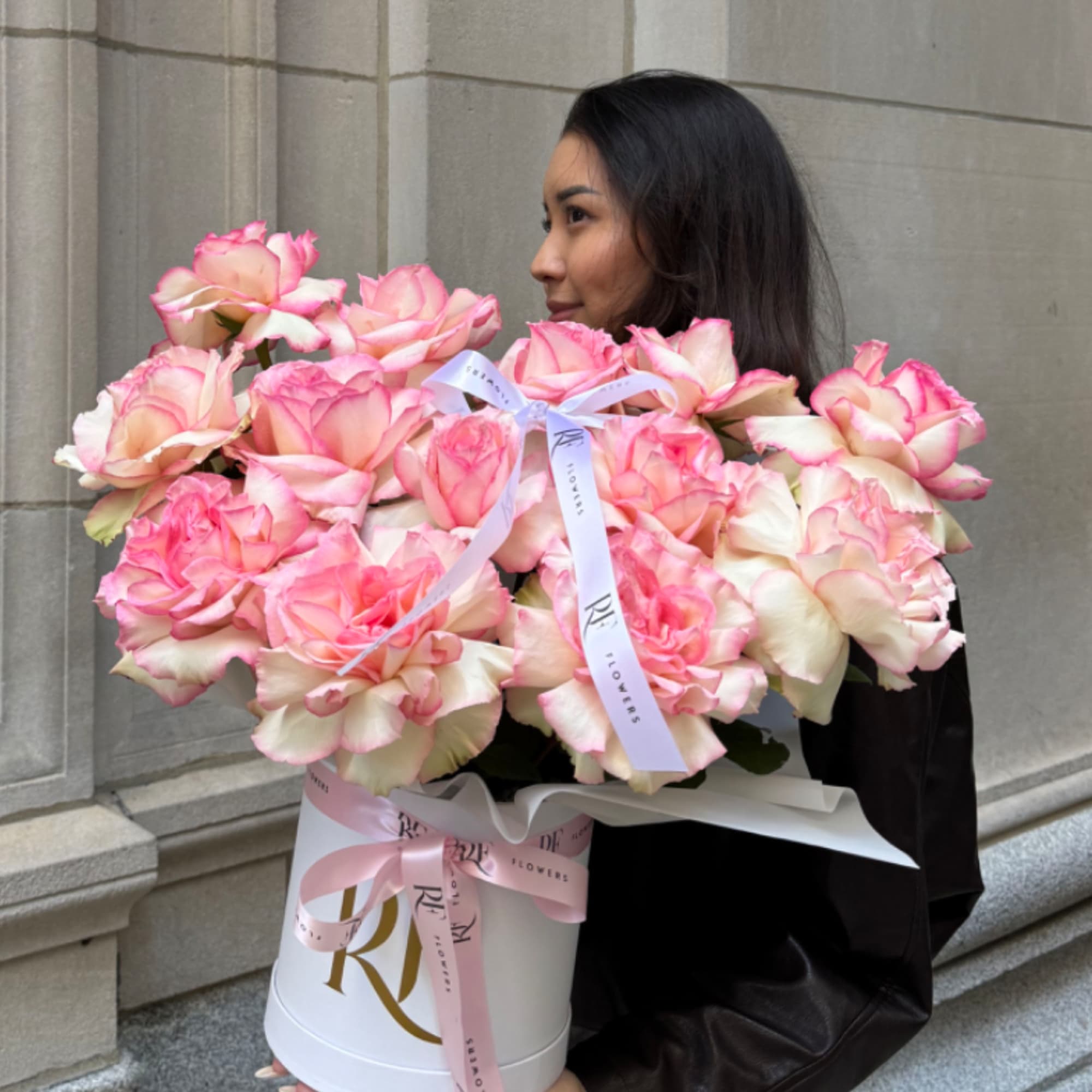 French-styled roses and lisianthus arranged in a round box.
