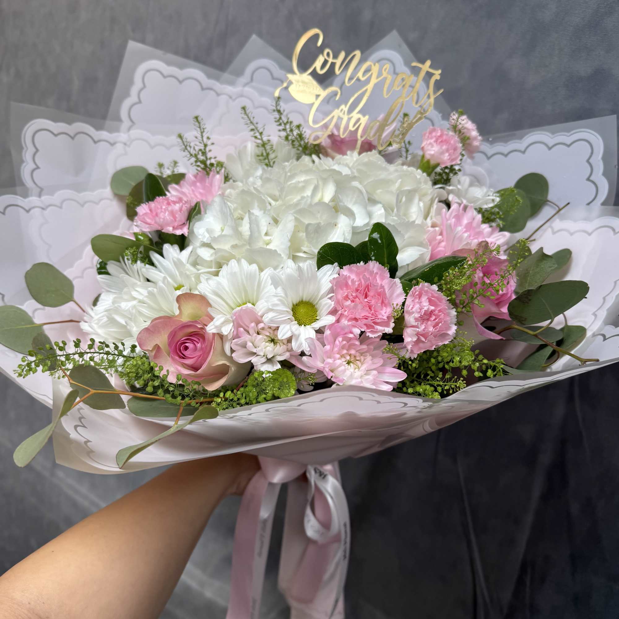 A timeless arrangement featuring white hydrangeas, soft pink roses, delicate carnations, and A timeless arrangement featuring white hydrangeas, soft pink roses, delicate carnations, and