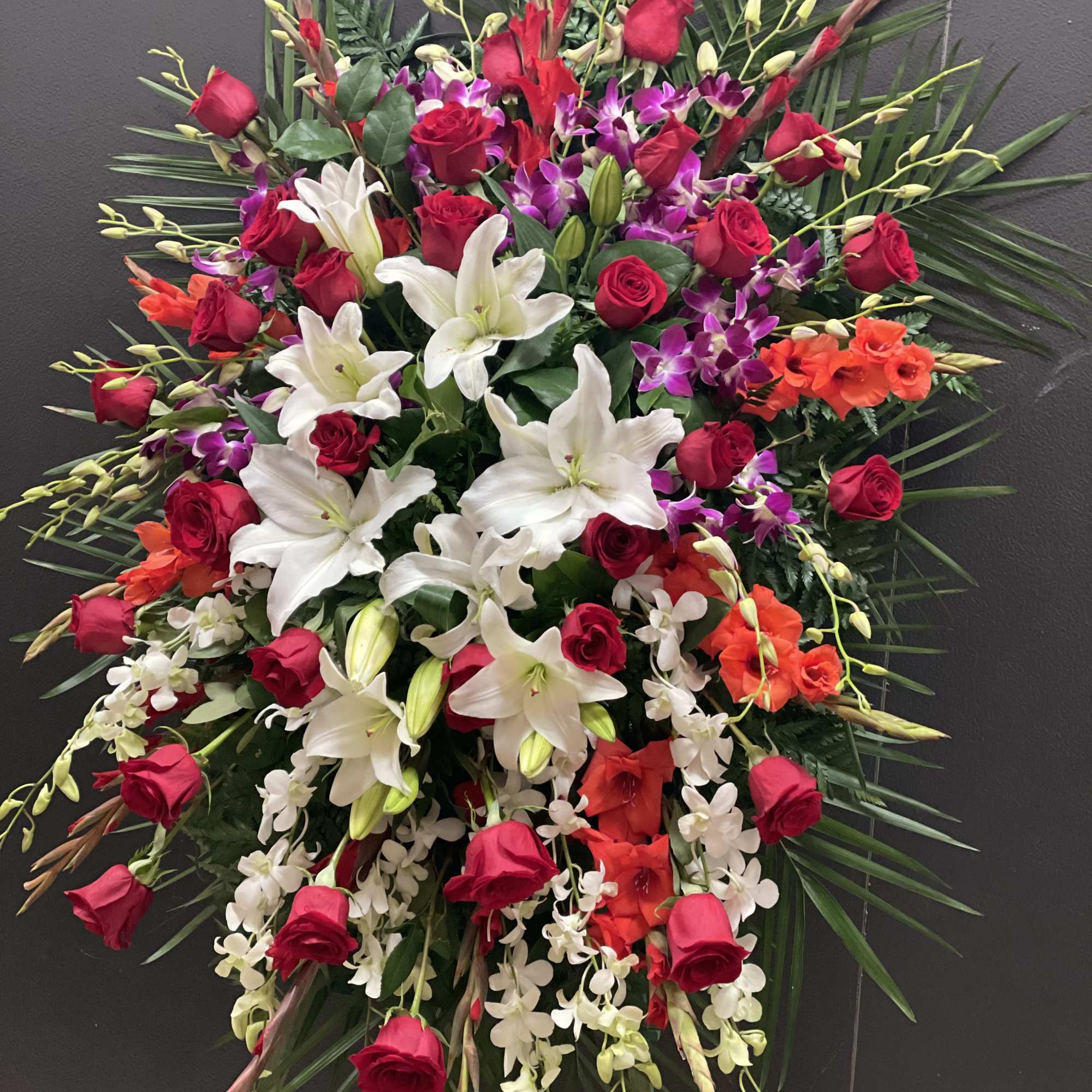 This Grand and Beautiful standing spray, made with purple and white dendrobium